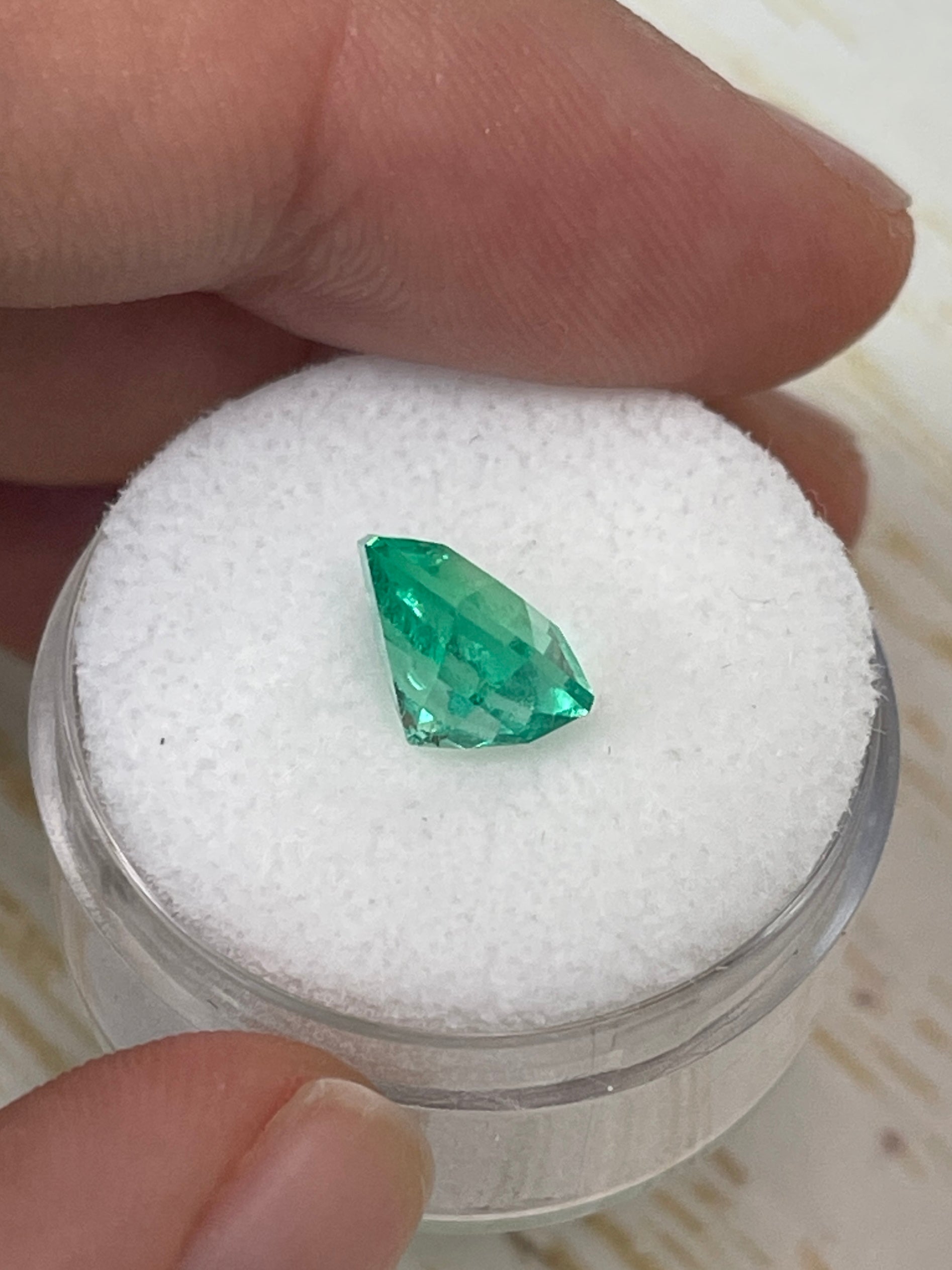 2.76 carat vivacious natural Colombian emerald loose Asscher cut with clipped corners, showcasing vibrant green color and clarity.
