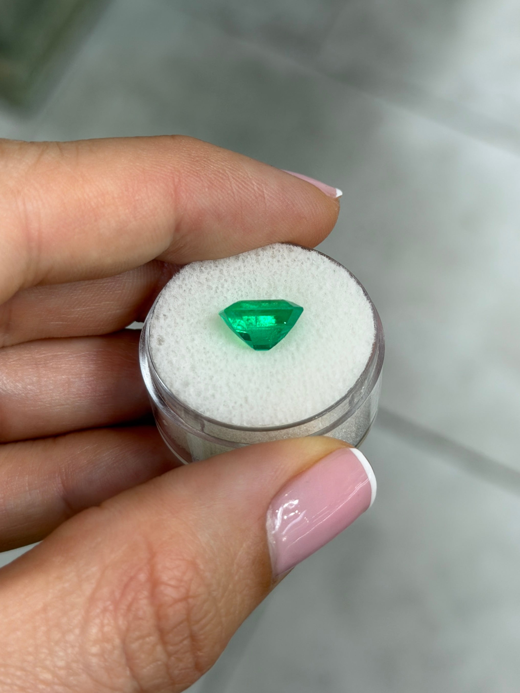 2.80 carat Kryptonite vivid green natural Colombian emerald loose gemstone in an emerald cut.