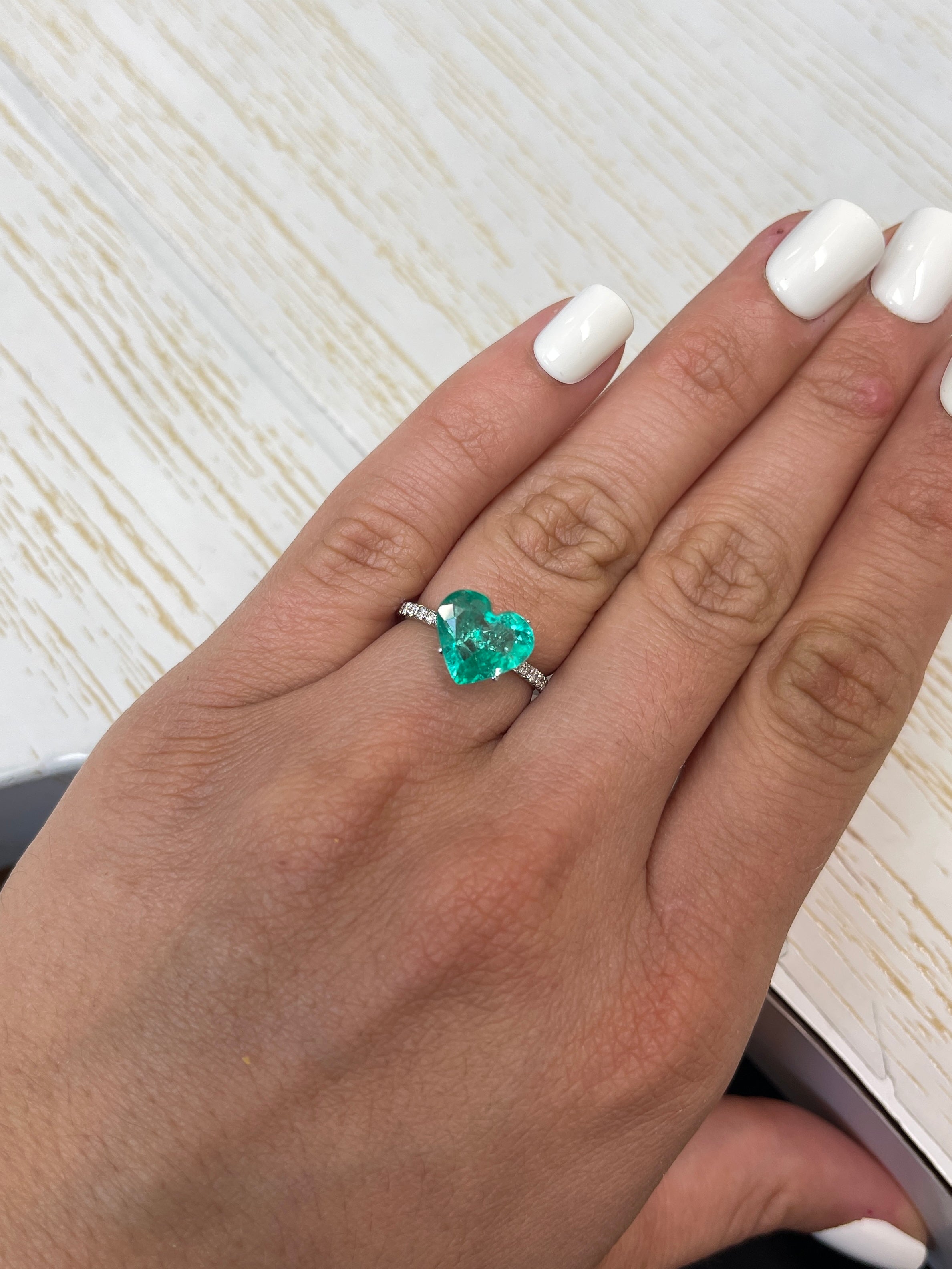 Bright green 2.84 carat natural Colombian emerald in heart cut, loose gemstone showcasing vibrant color and clarity.