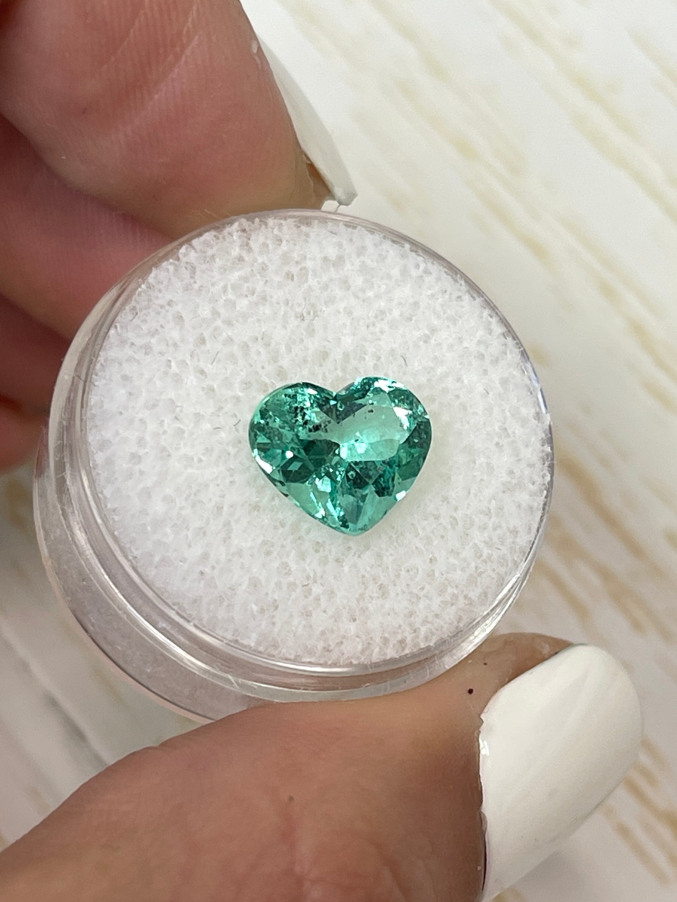 Lustrous 2.87 Carat green Colombian emerald loose gemstone in heart cut, 9x11mm, with vibrant natural color from JR Colombian Emeralds.