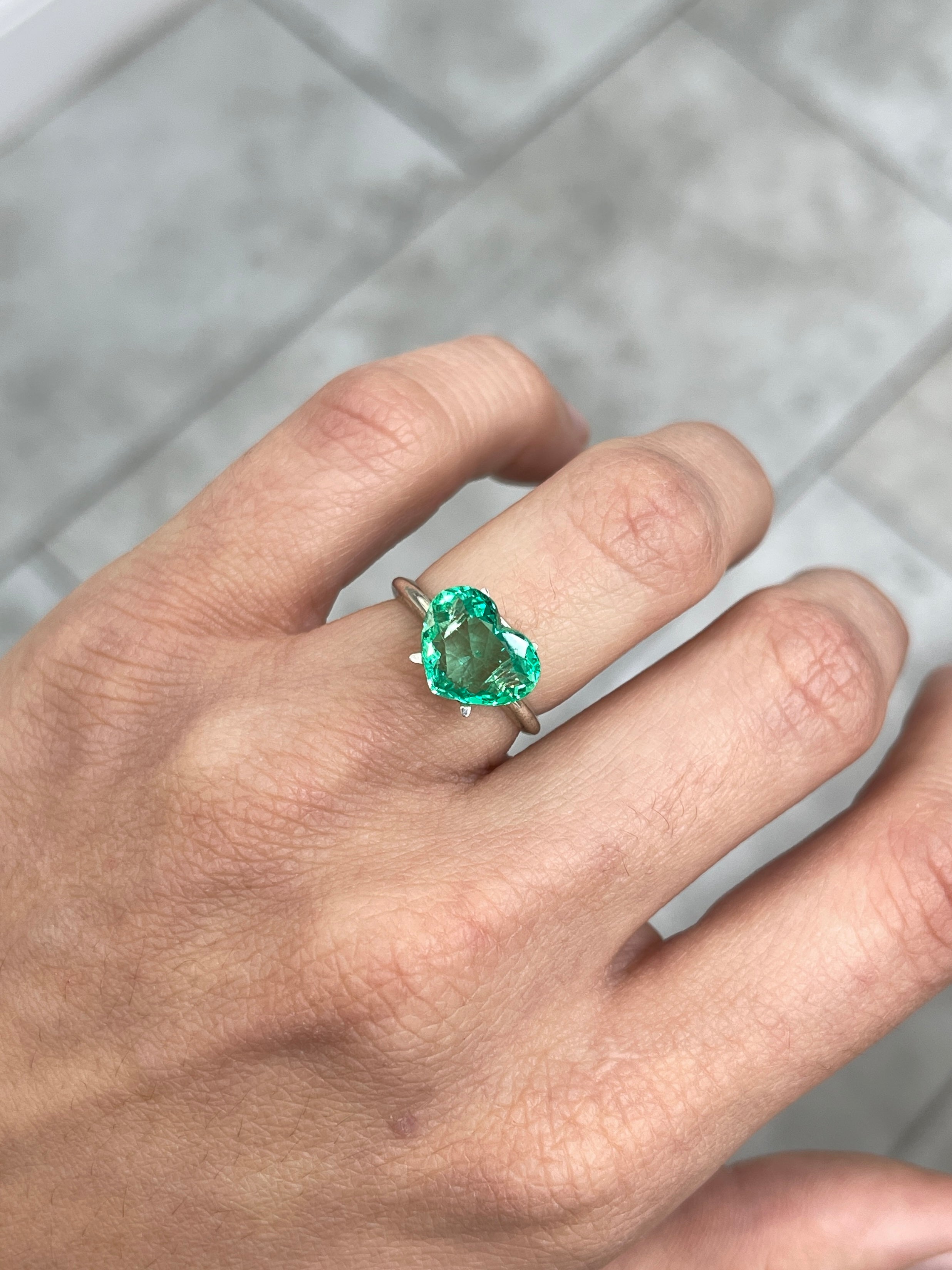 Natural 2.91 carat green Colombian emerald loose heart cut gemstone from JR Colombian Emeralds, showcasing vibrant glowing green color.