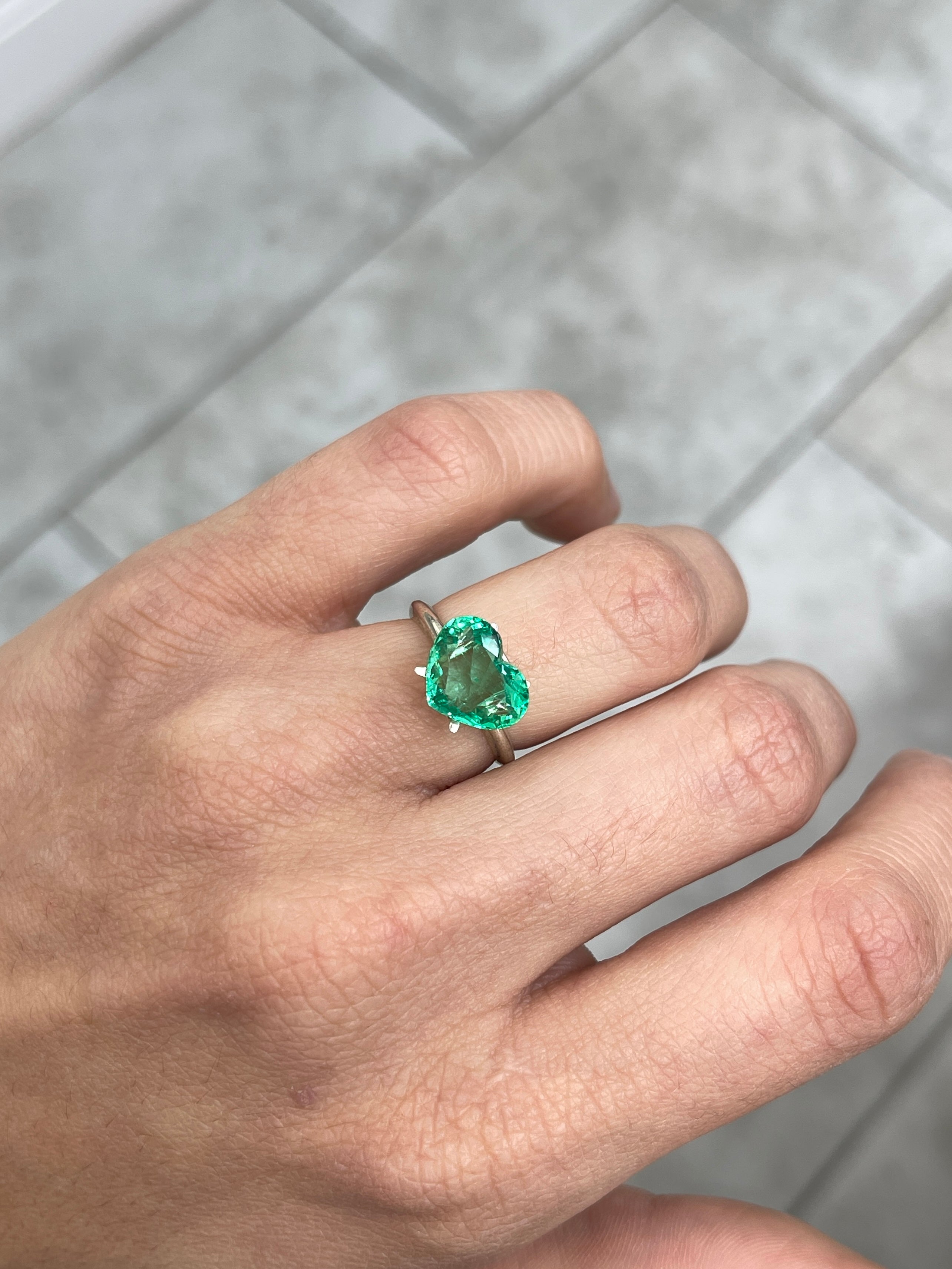2.91 carat green Colombian emerald loose gemstone with heart cut, showcasing vibrant glow and natural clarity.