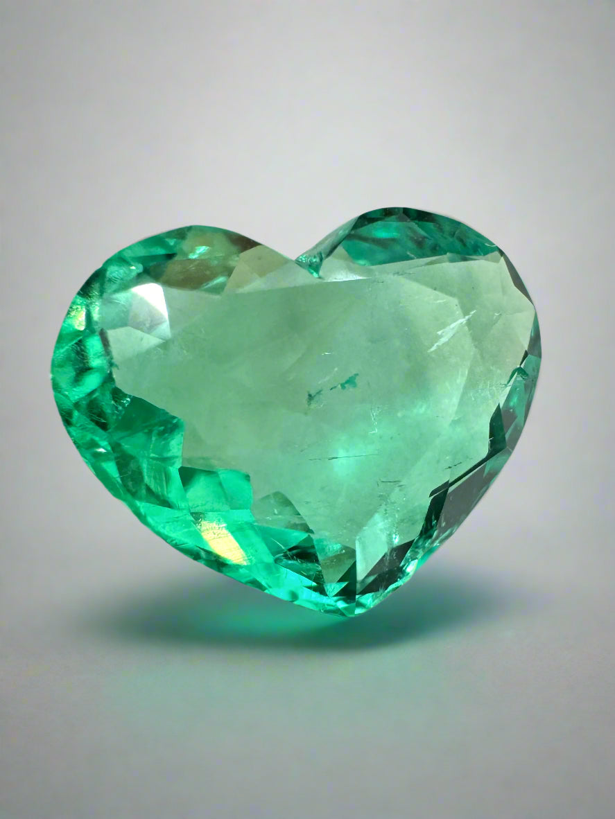 2.91 carat green Colombian emerald loose gemstone, heart cut, natural and glowing, displayed by JR Colombian Emeralds