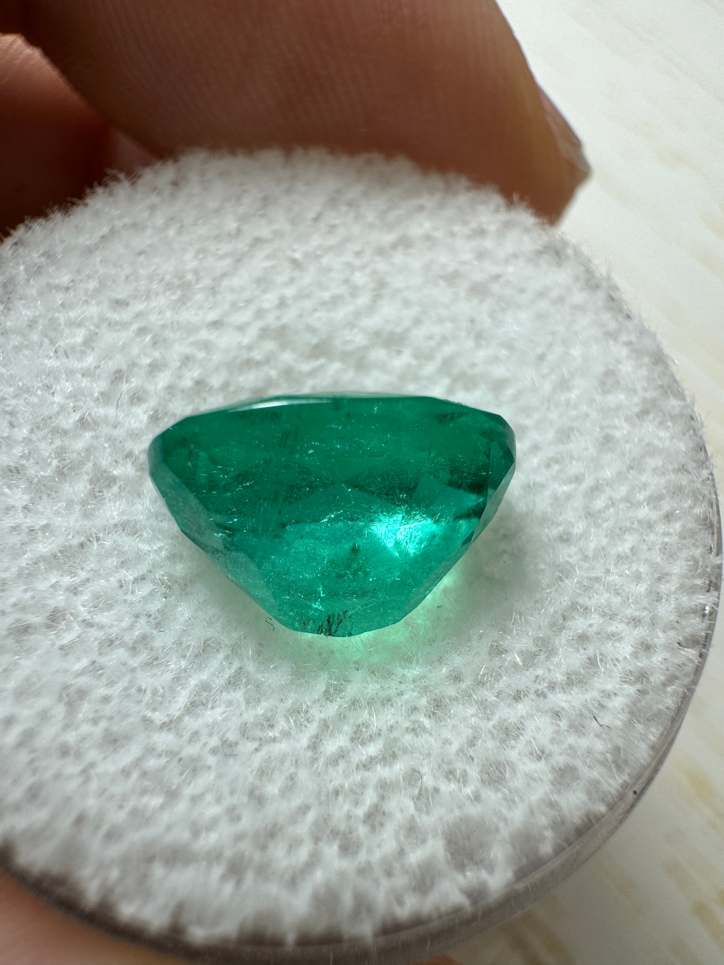 Elongated 2.95 carat Colombian emerald loose gemstone with oval cut and semi-transparent green color, from JR Colombian Emeralds.