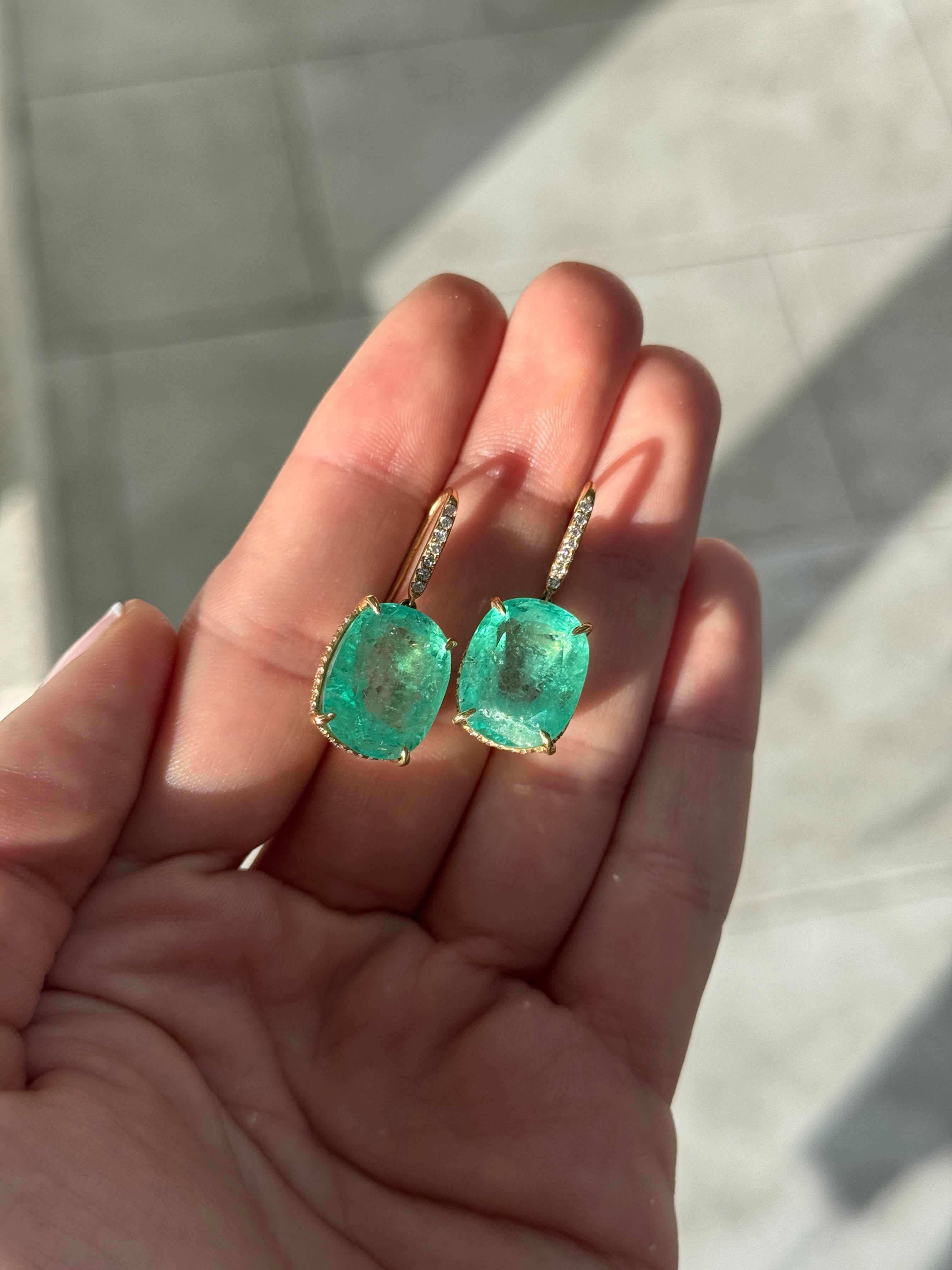 Large cushion cut Colombian emerald and diamond dangle earrings in 18K gold featuring 25.70tcw from JR Colombian Emeralds.