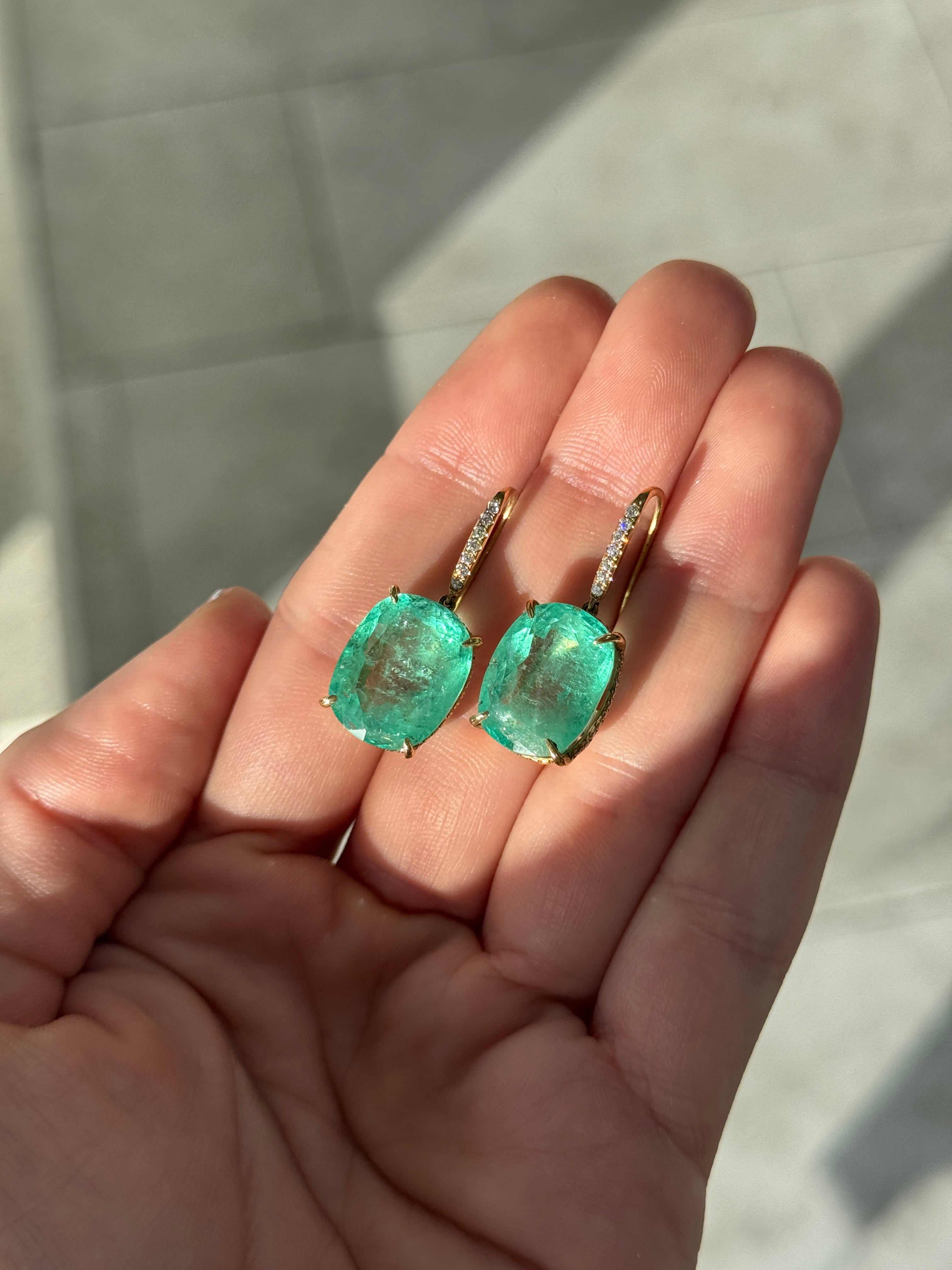 Large cushion cut Colombian emerald and diamond dangle earrings in 18K gold from JR Colombian Emeralds featuring 25.70tcw gemstones.