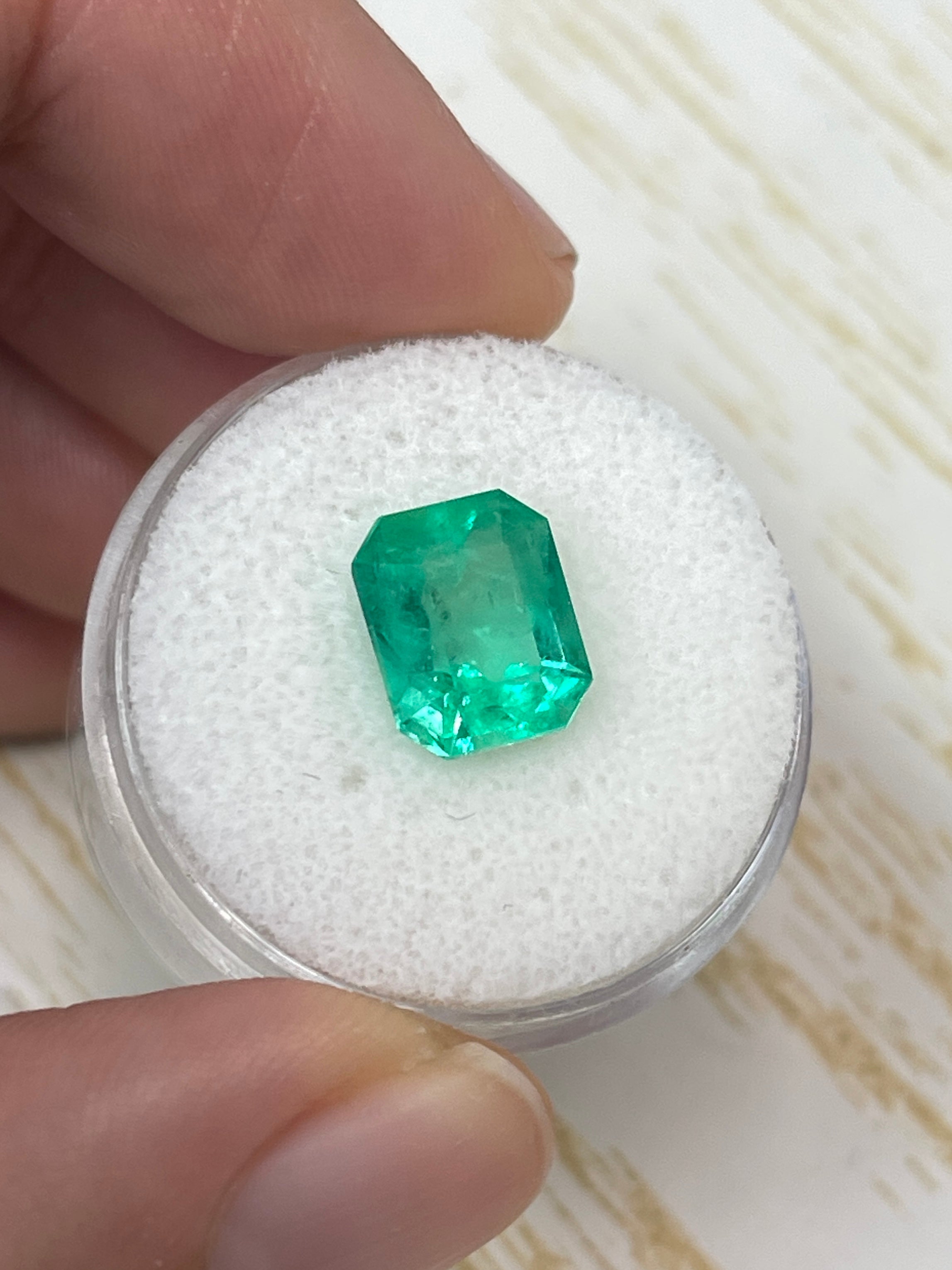 Electric yellowish 3.09 carat Colombian emerald in 10x8 emerald cut, from JR Colombian Emeralds, showcasing its vibrant color and clarity.