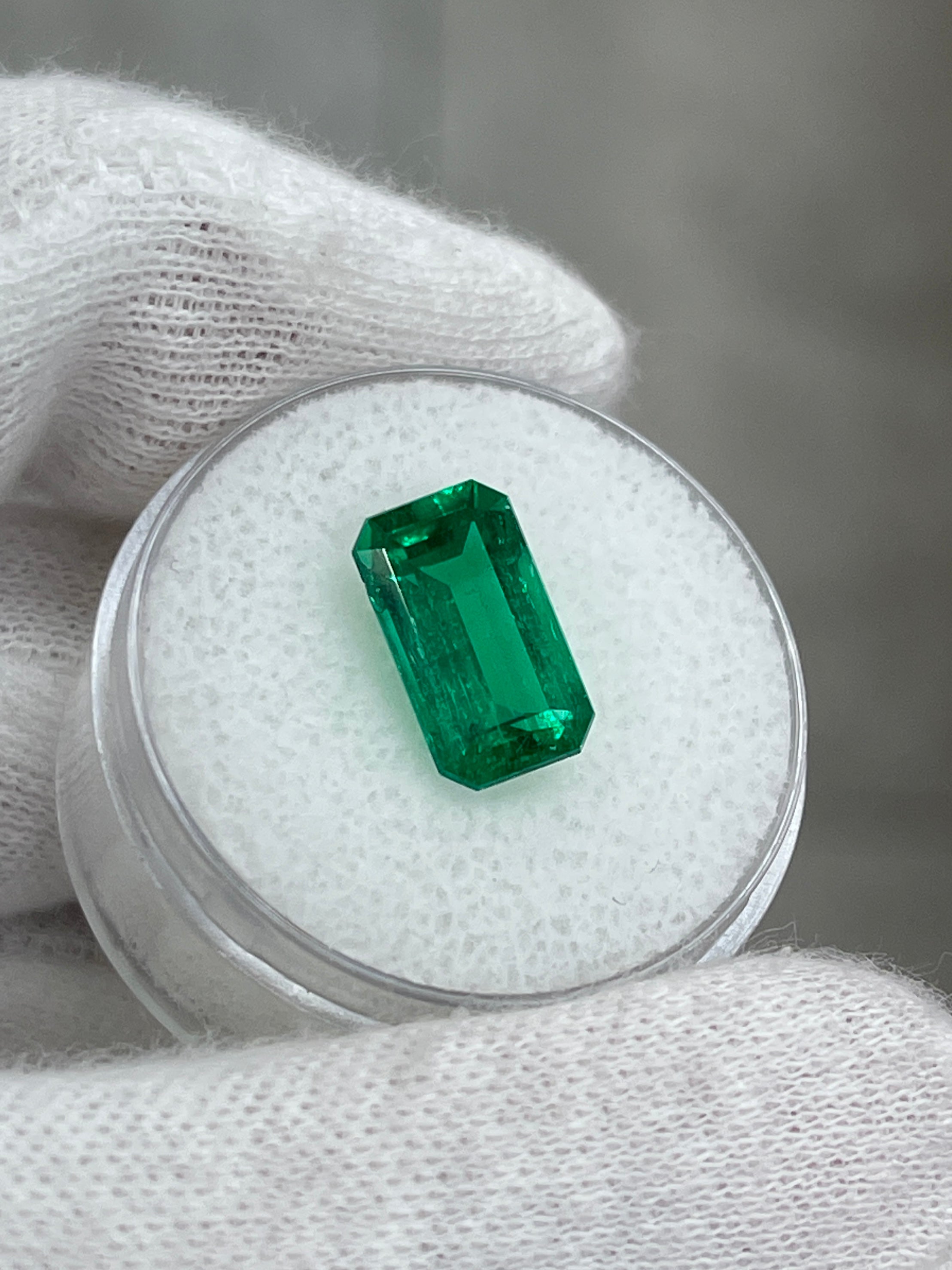 AAA+ 3.10 Carat natural Colombian emerald loose gemstone in elongated emerald cut, featuring minor oil treatment.