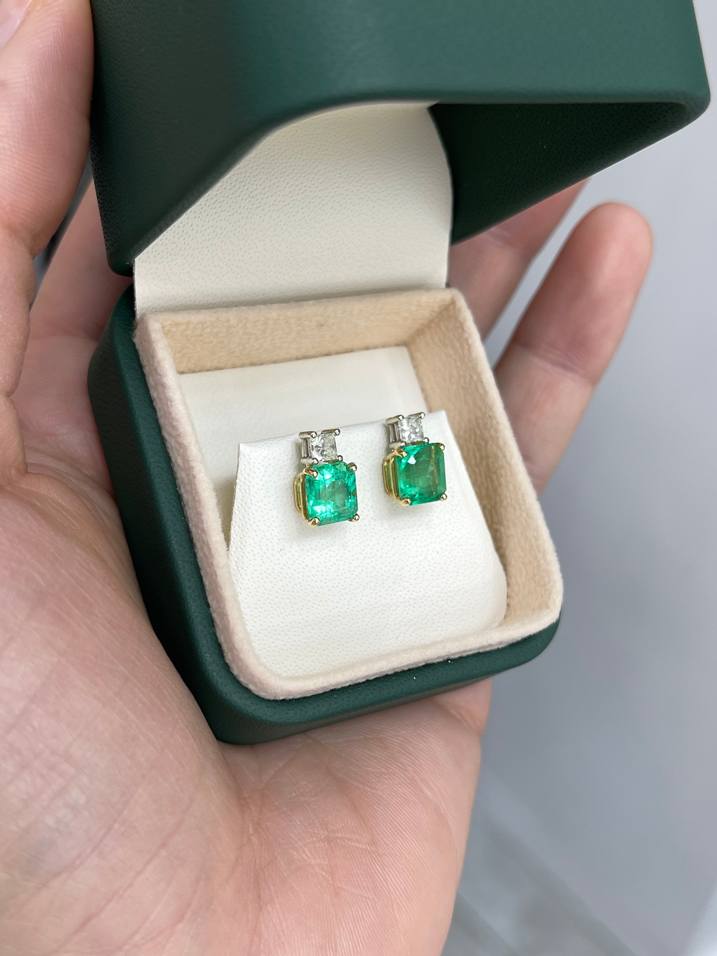 Three point ten carat Colombian emerald and princess cut diamond earrings in 18K two-tone gold, featuring intricate jewelry design.