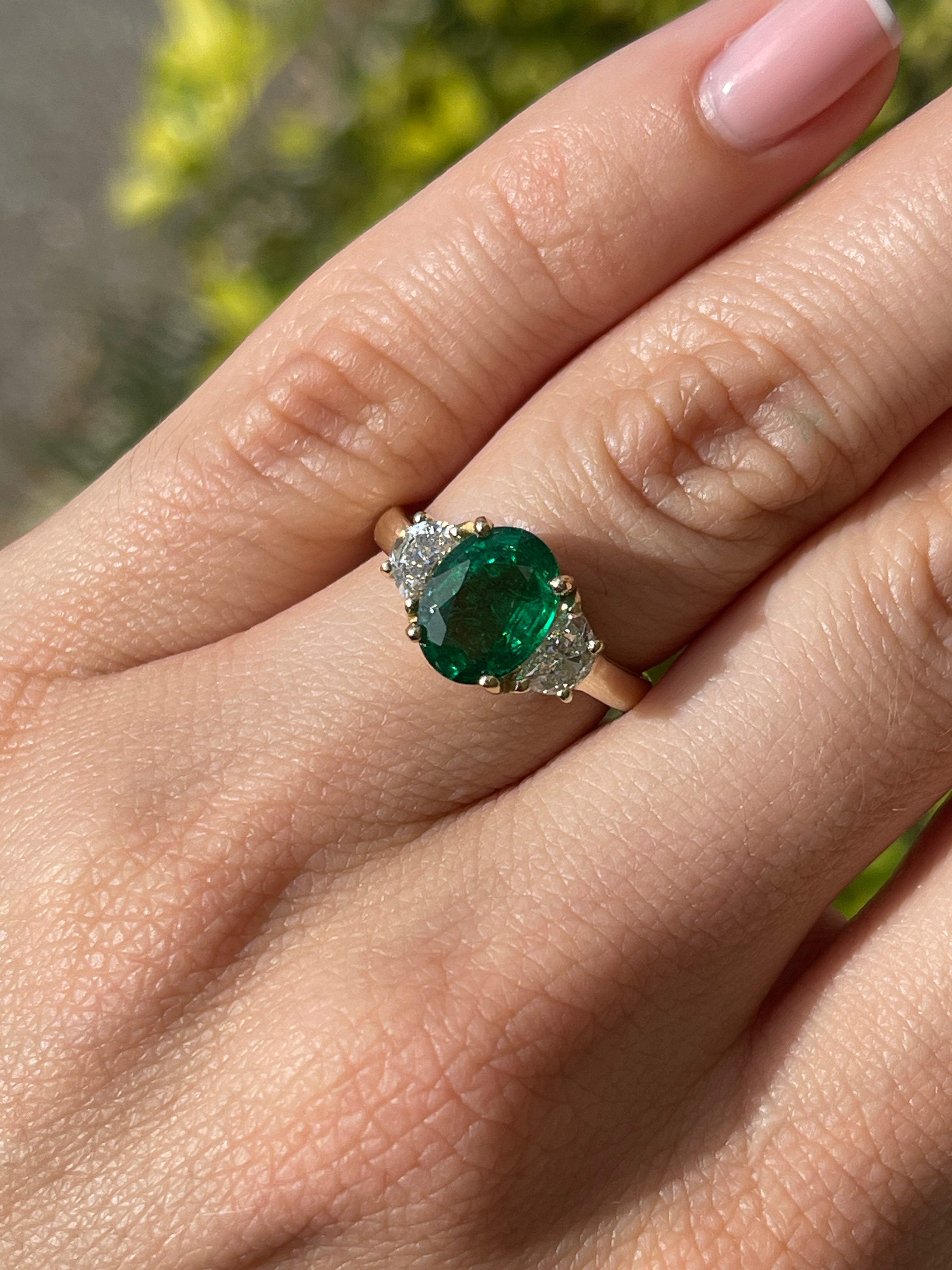 Oval emerald and half-moon lab diamond three-stone ring in 14K gold with JR Colombian Emeralds branding.