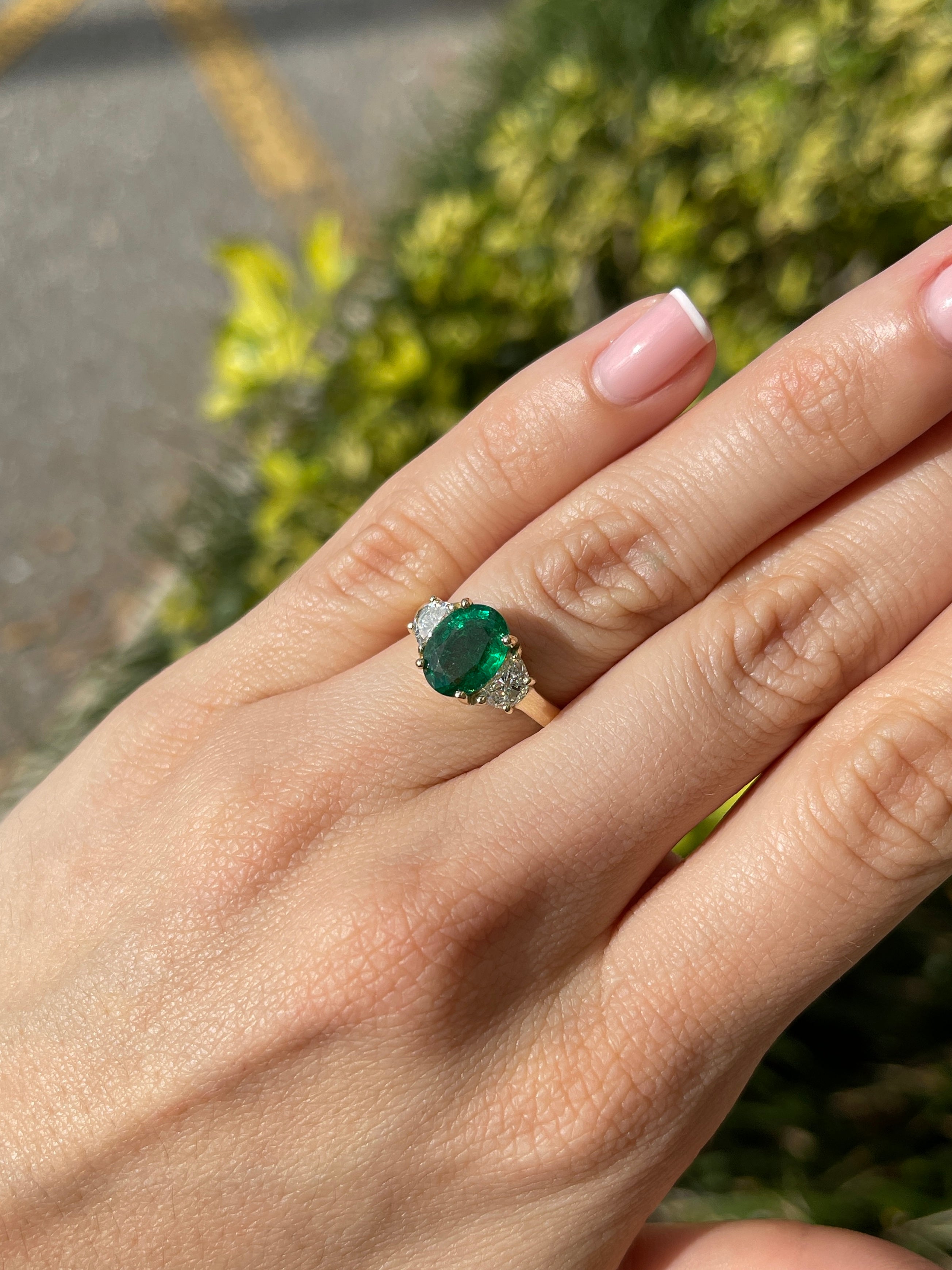 Natural oval emerald and half-moon lab diamond 14K gold three-stone ring by JR Colombian Emeralds, showcasing sparkling gemstones.