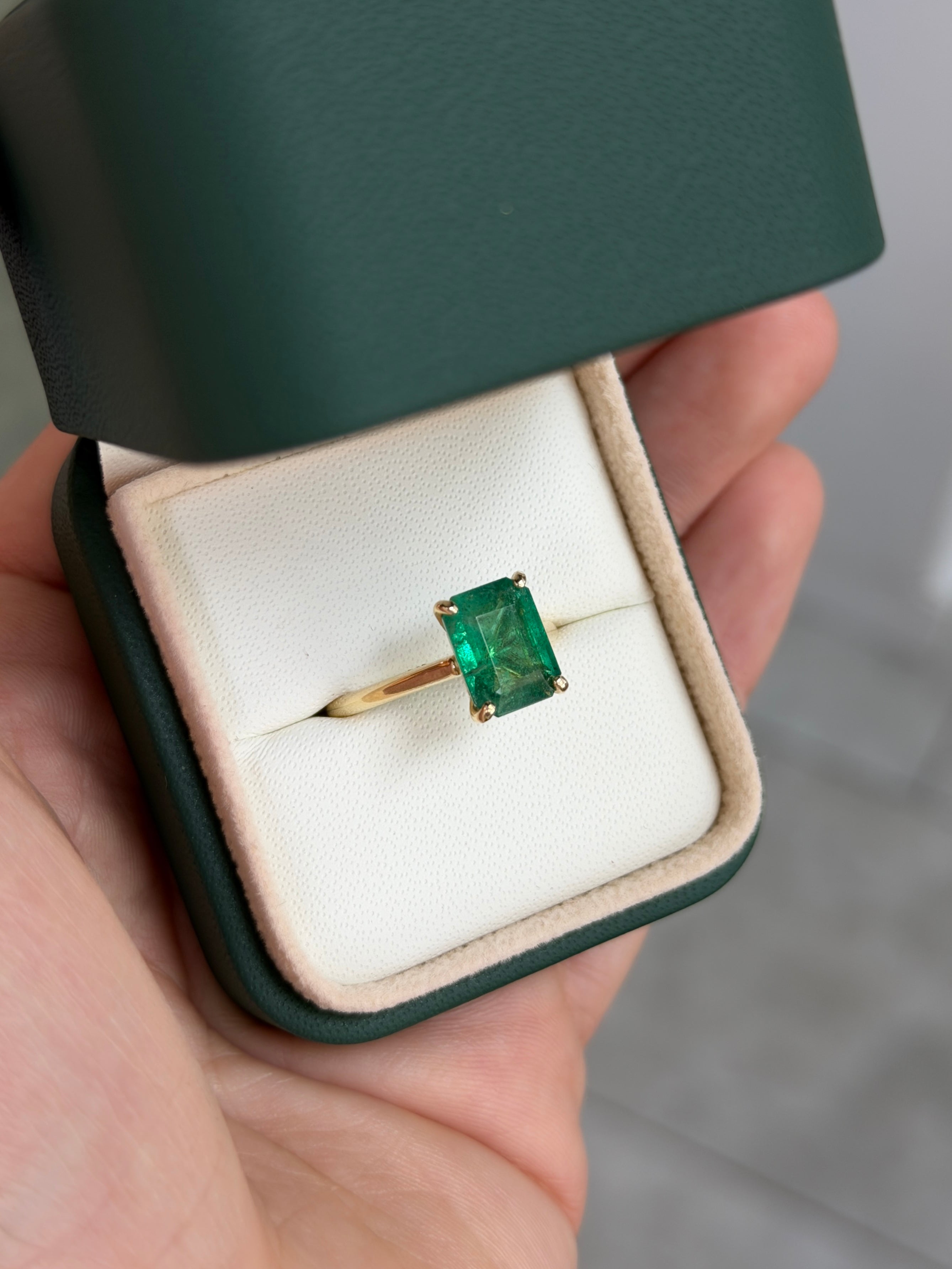 14K gold emerald cut emerald engagement ring with hidden diamonds from JR Colombian Emeralds, showcasing the detailed gallery design.