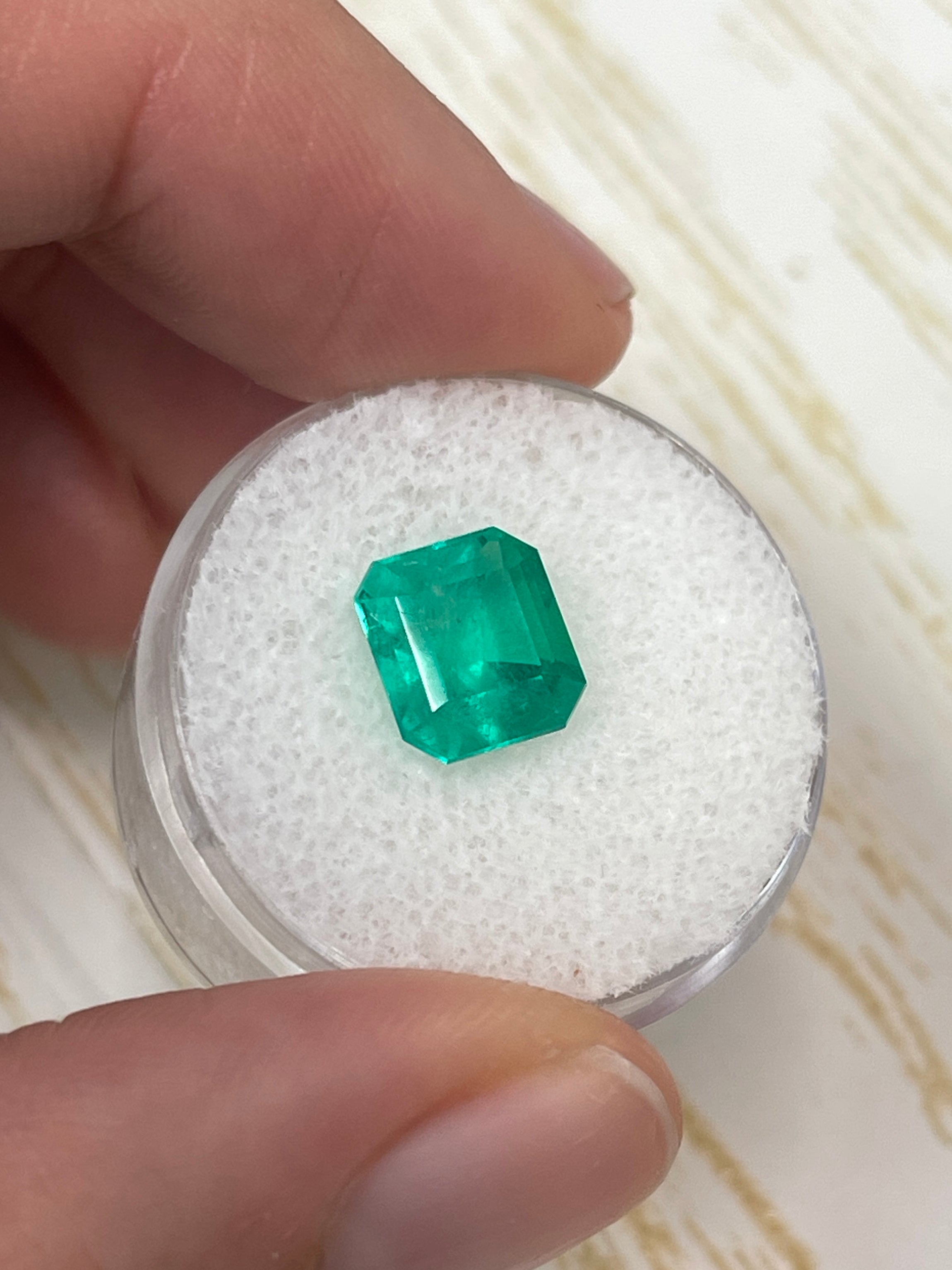 3.22 carat bluish green natural Colombian emerald loose gemstone in an emerald cut, showcased by JR Colombian Emeralds.