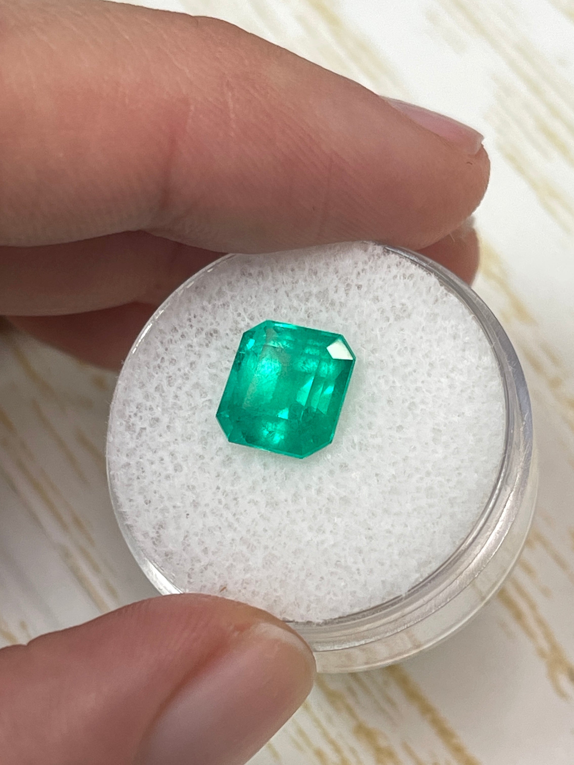 3.22 carat bluish green natural Colombian emerald in an emerald cut, displayed as a loose gemstone by JR Colombian Emeralds.