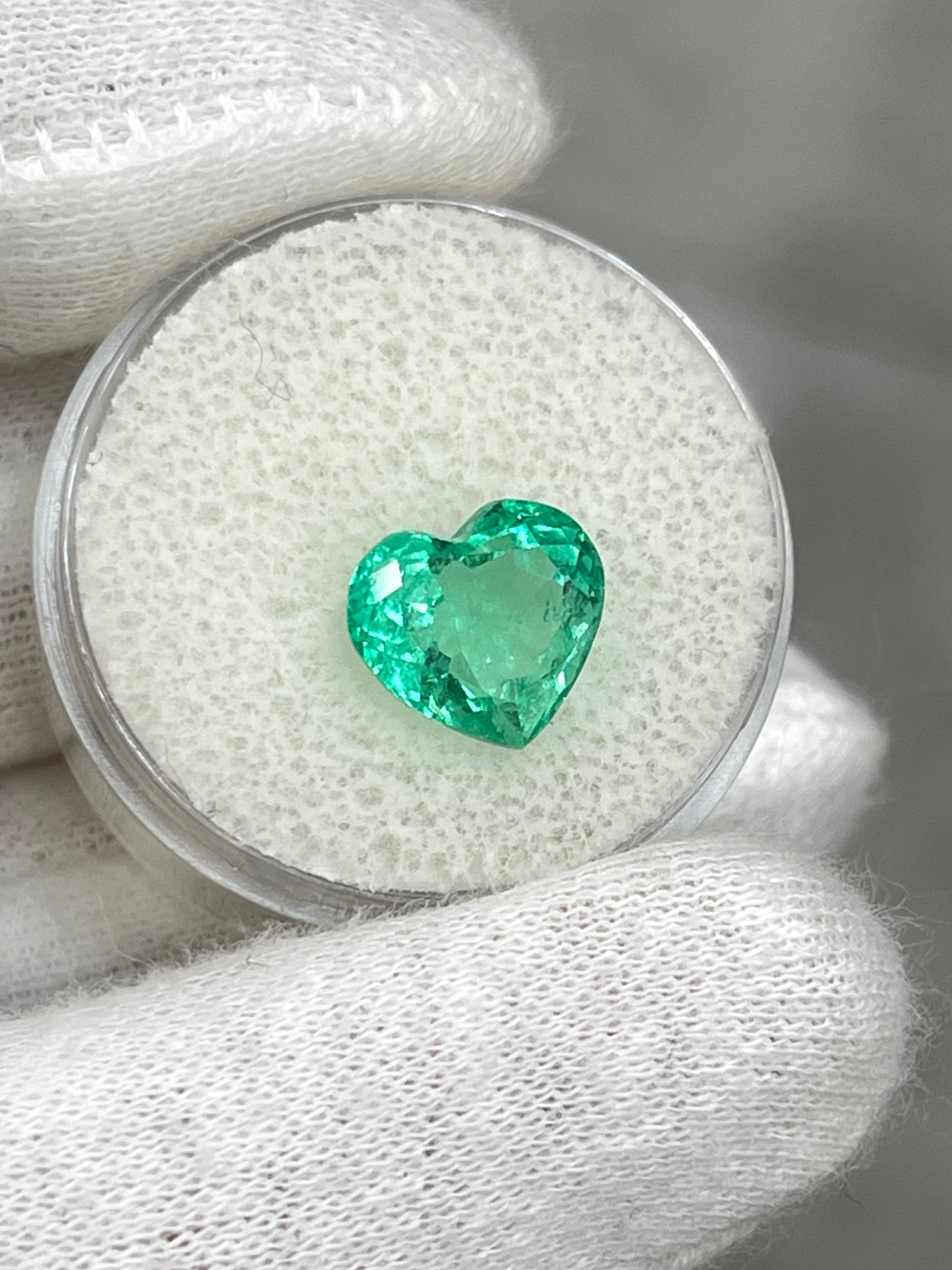 Bright medium green 3.24 carat Colombian emerald in heart cut, showcasing vibrant color and clarity, from JR Colombian Emeralds.
