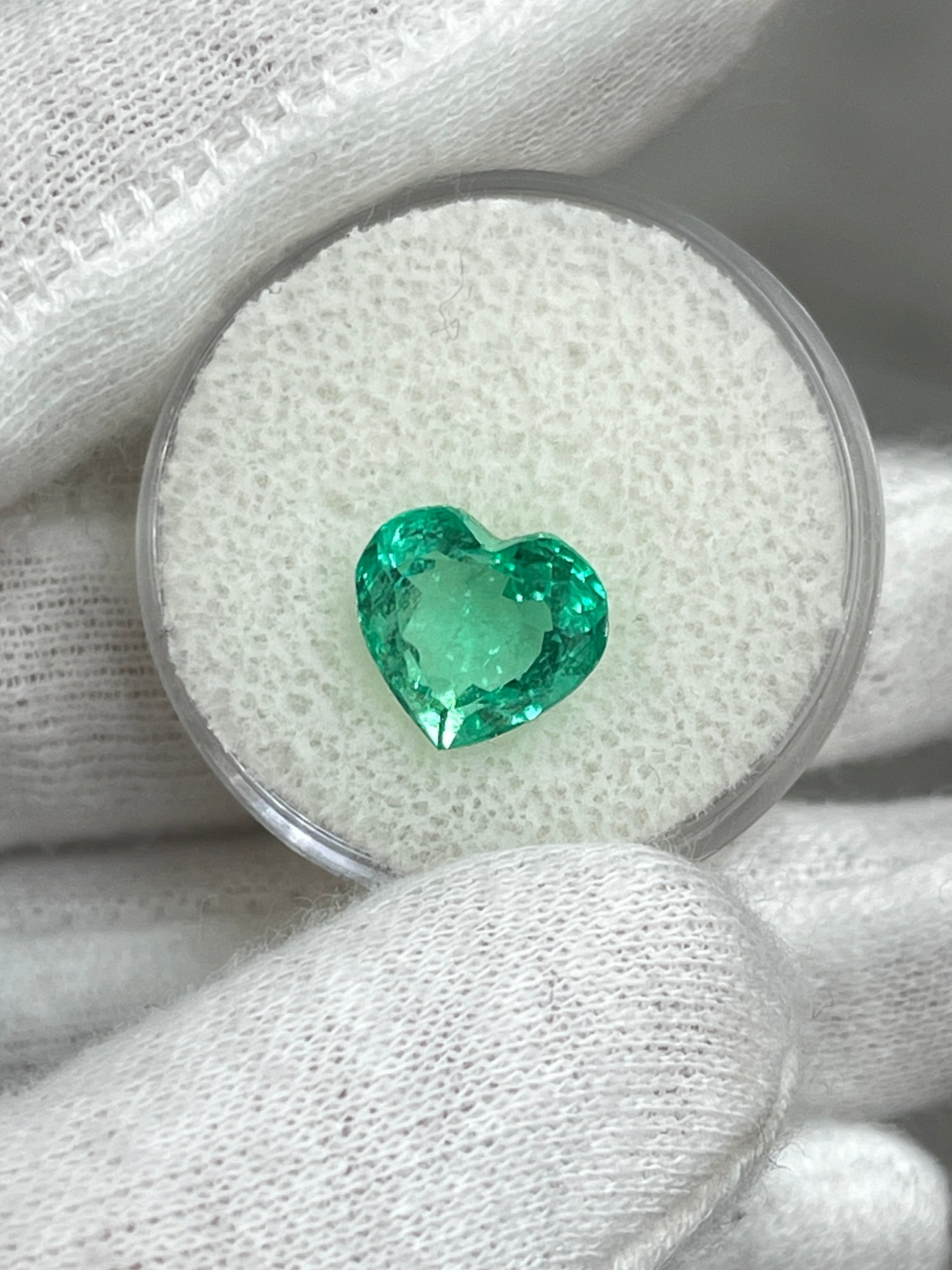 Bright medium green 3.24 carat Colombian emerald in heart cut, showcasing vivid color and clarity, by JR Colombian Emeralds.