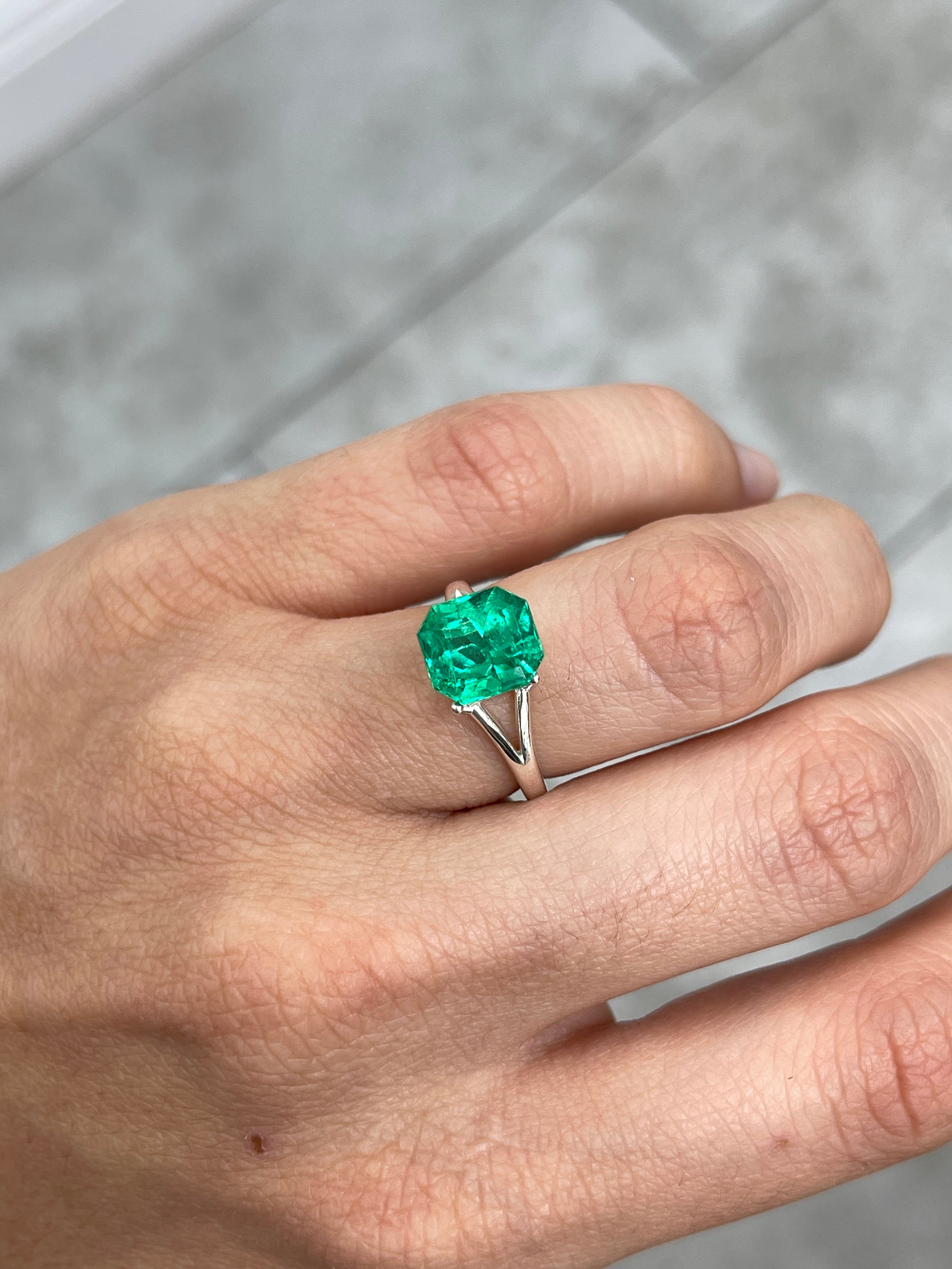 Vivid yellowish-green Colombian emerald, 3.26 carats, emerald cut, displayed by JR Colombian Emeralds.