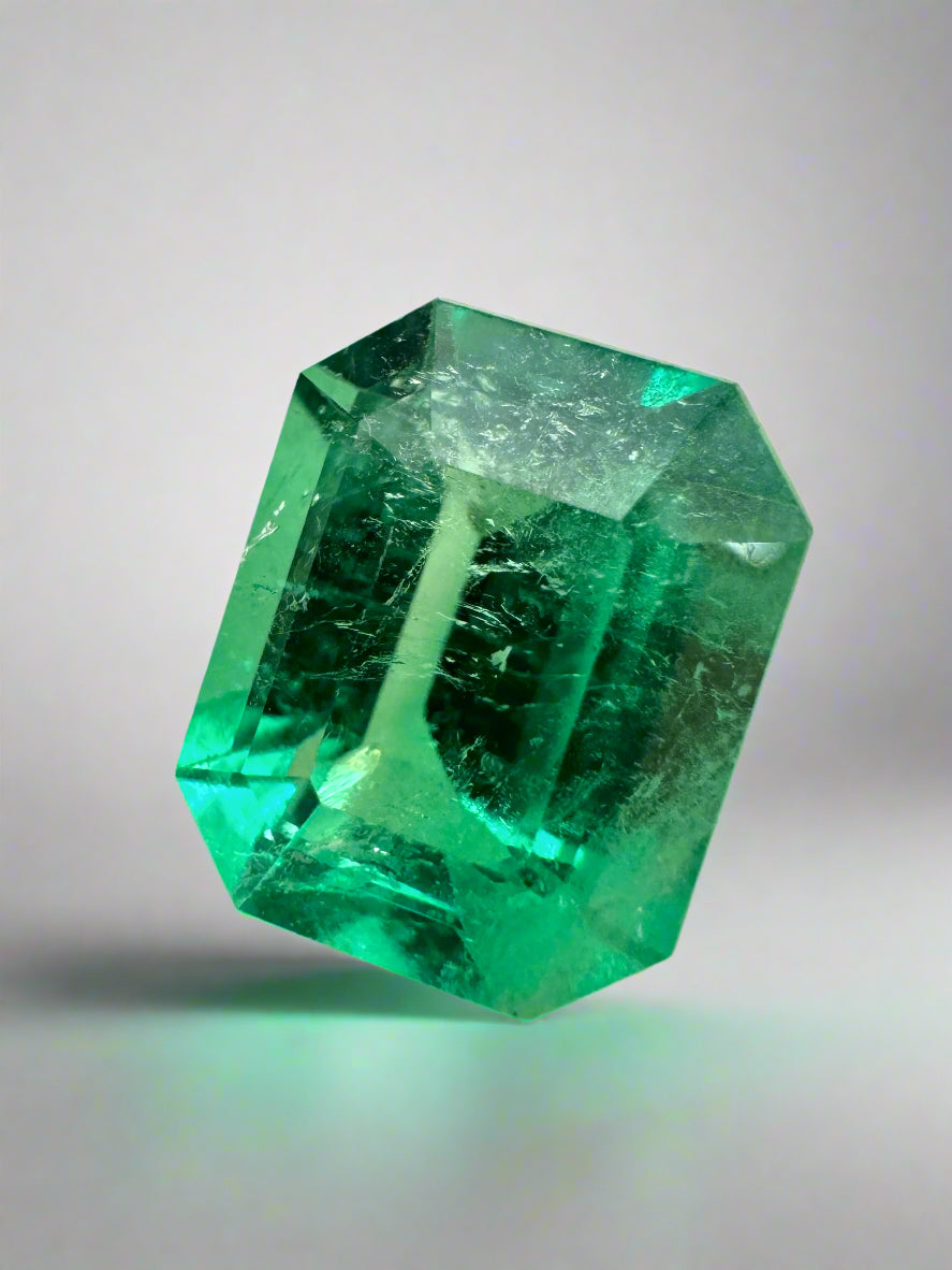 Bright green 3.30 carat natural Colombian emerald in an emerald cut, showcasing its glowing, rich green color and clarity.