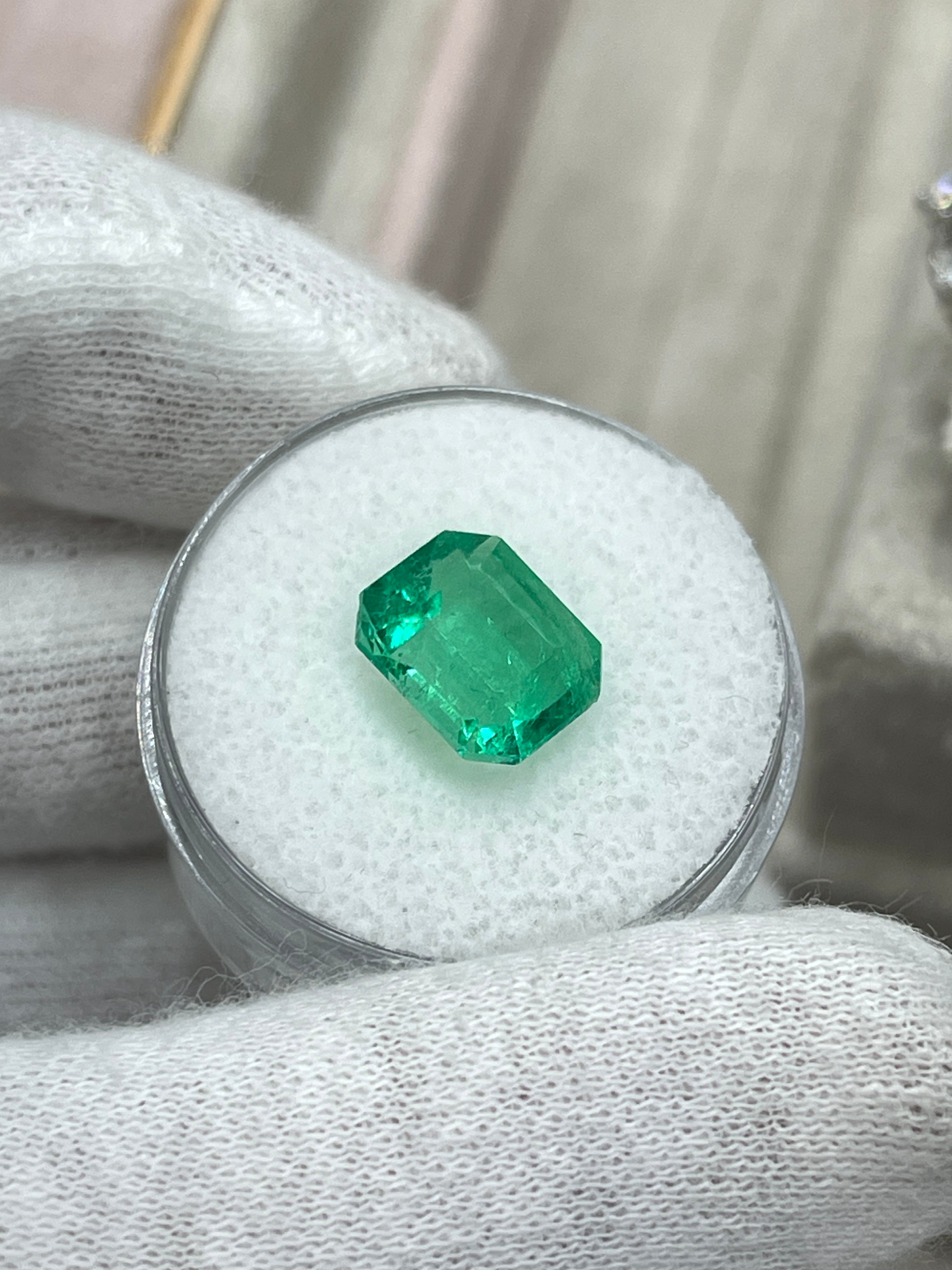 3.30 carat glowing green natural Colombian emerald loose gemstone in emerald cut with vibrant color and clarity.