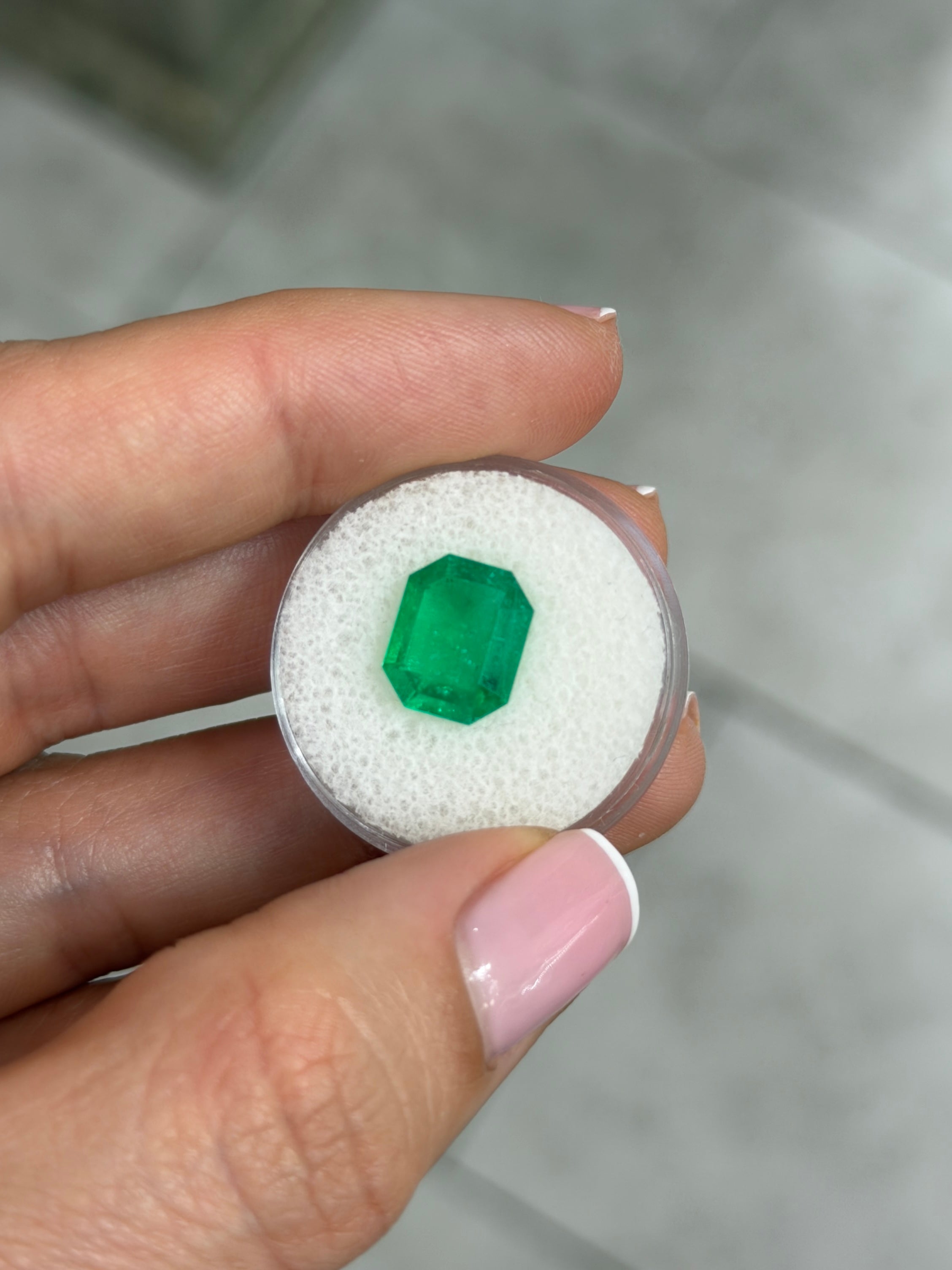 Natural 3.30 carat Muzo green Colombian emerald cut loose gemstone with classic emerald shape and vibrant green color.