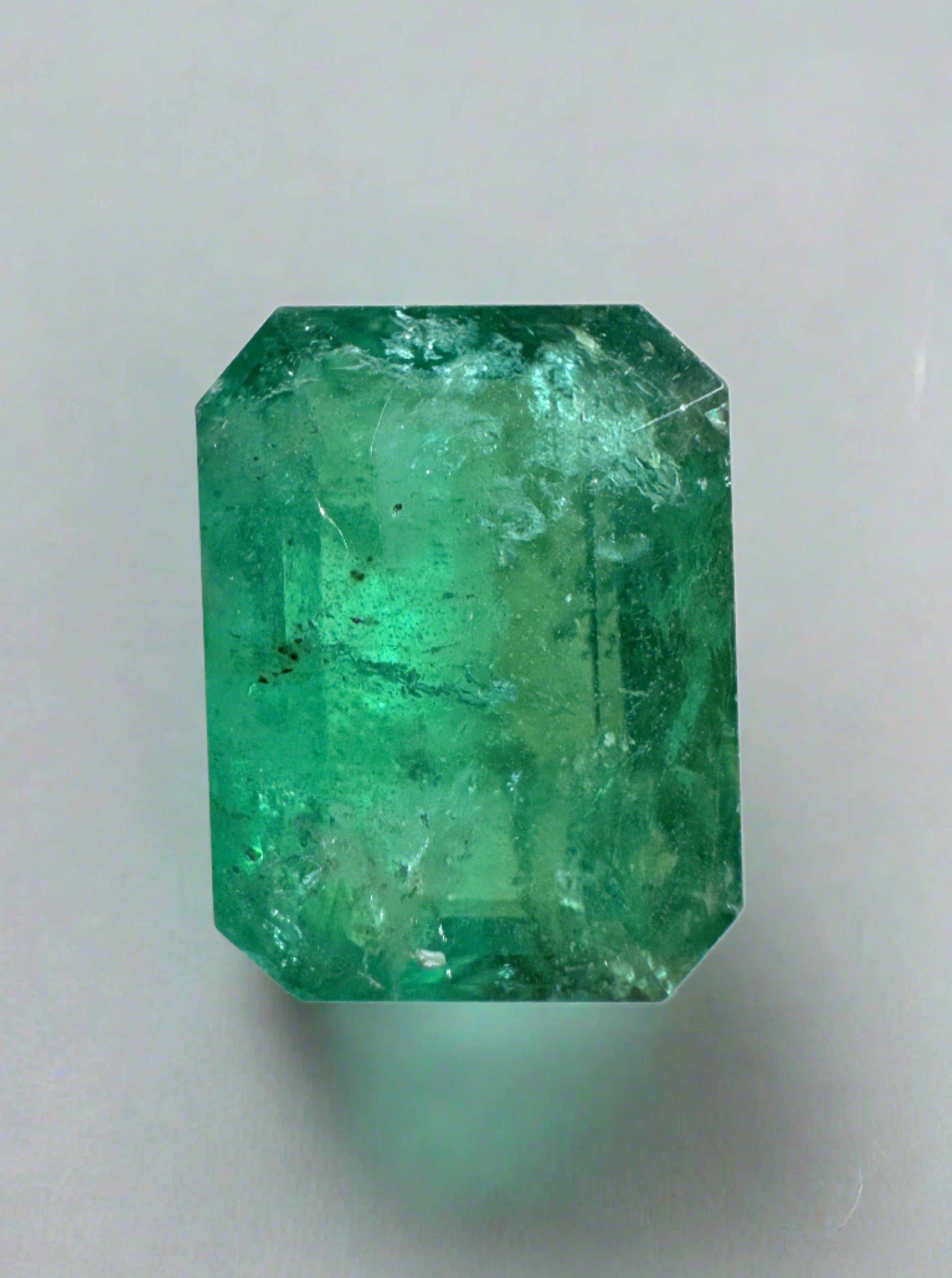 3.31 Carat mossy green natural Zambian emerald loose gemstone in an emerald cut, showcasing rich color and clarity.