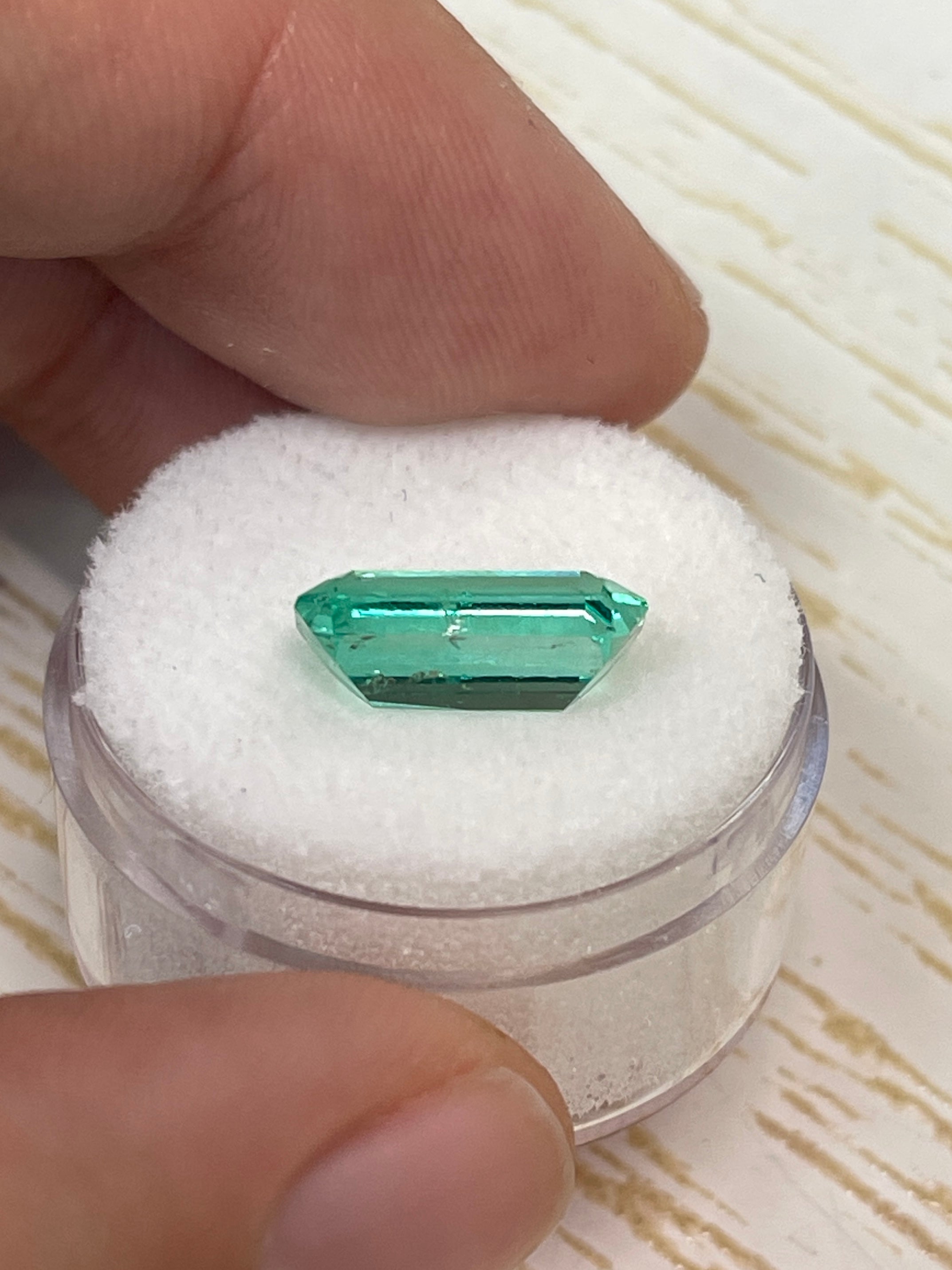 Elongated 3.42 carat natural Colombian emerald loose gemstone with emerald cut, vibrant green color and glowing clarity.