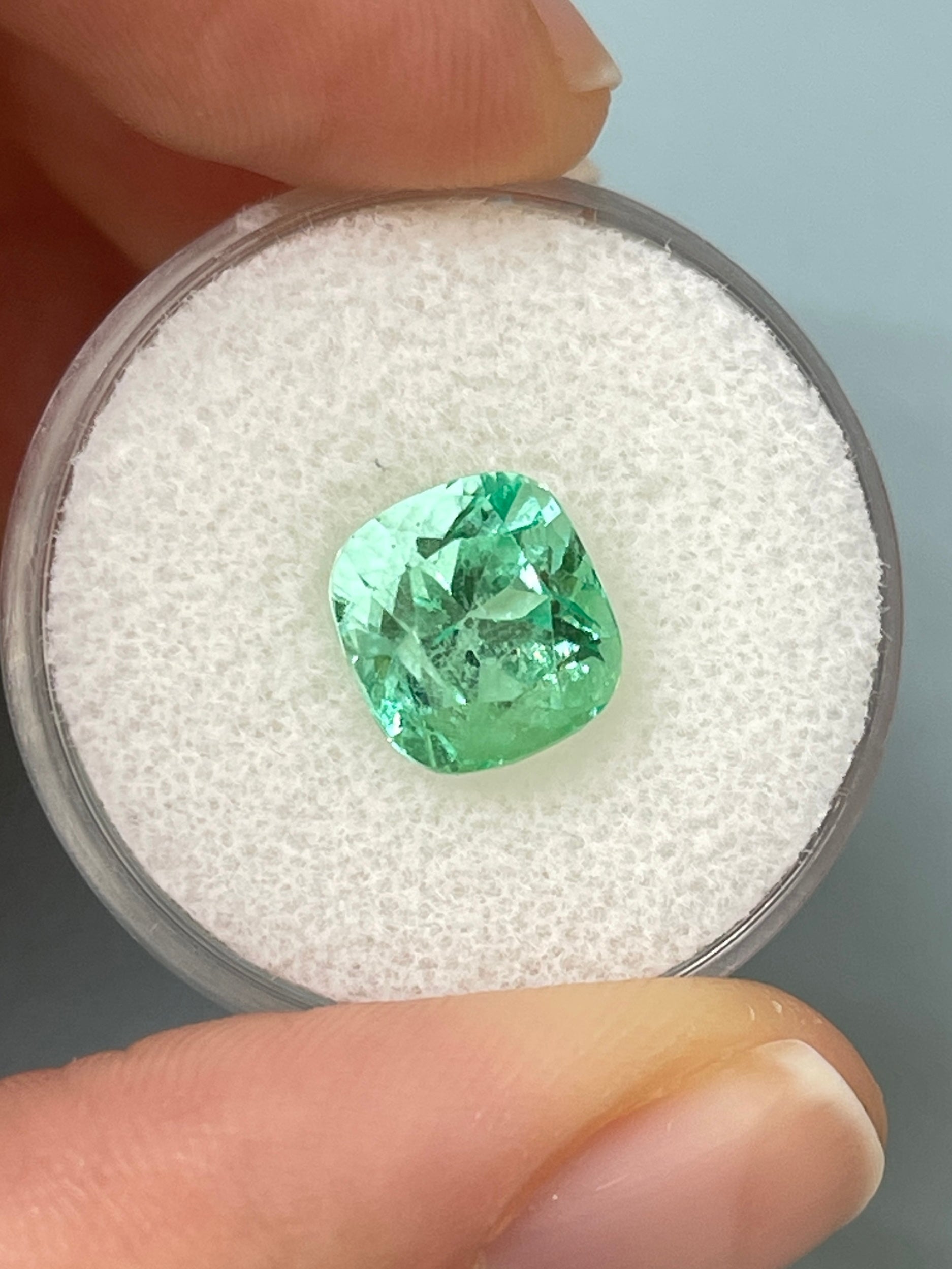 Lustrous 3.42 carat light yellowish green Colombian emerald loose cushion cut gemstone with natural clarity and vibrant color.