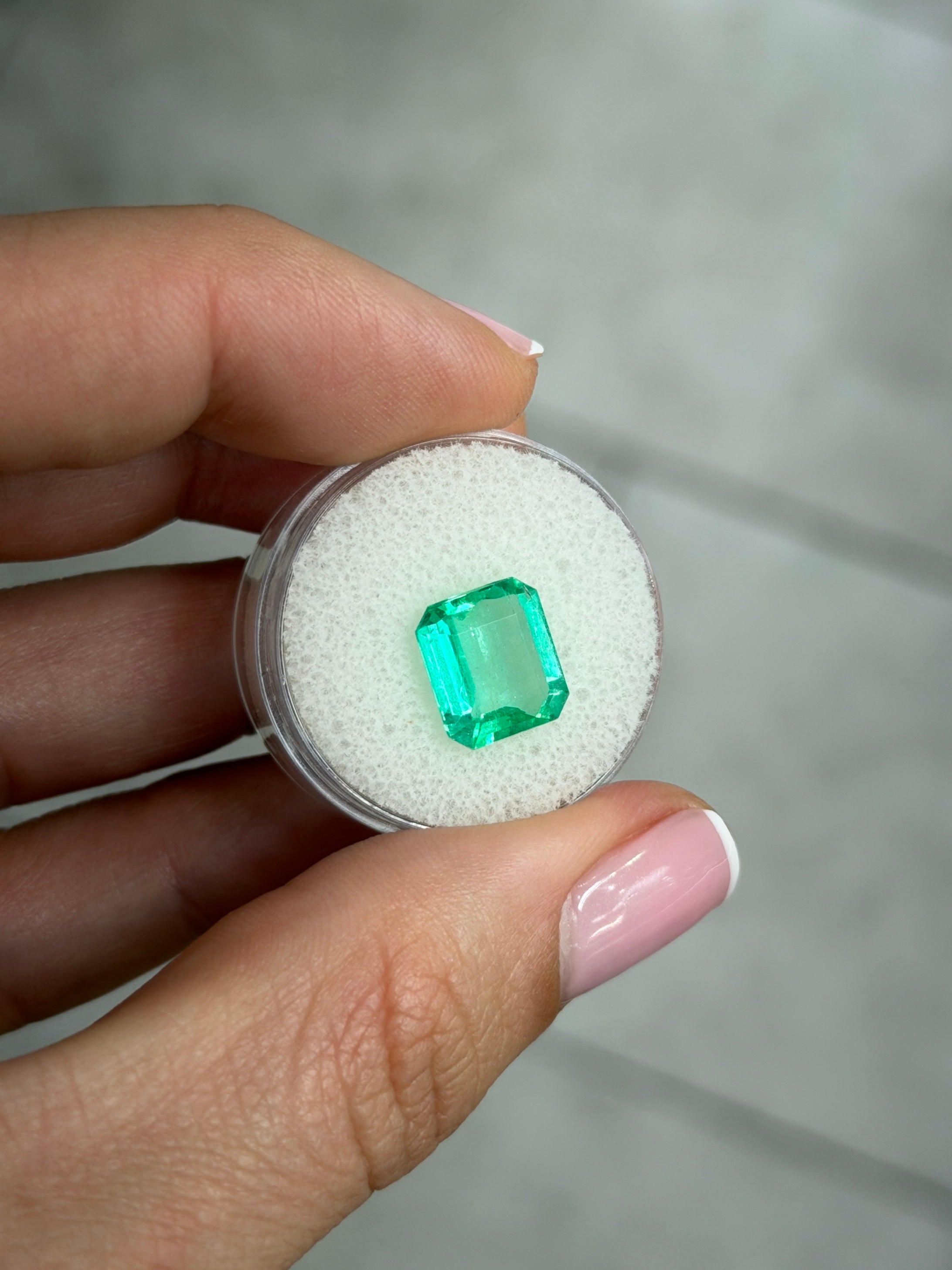3.54-carat crystal-clear green Colombian emerald loose gemstone in portrait cut, showcasing vibrant natural color and emerald cut facets.