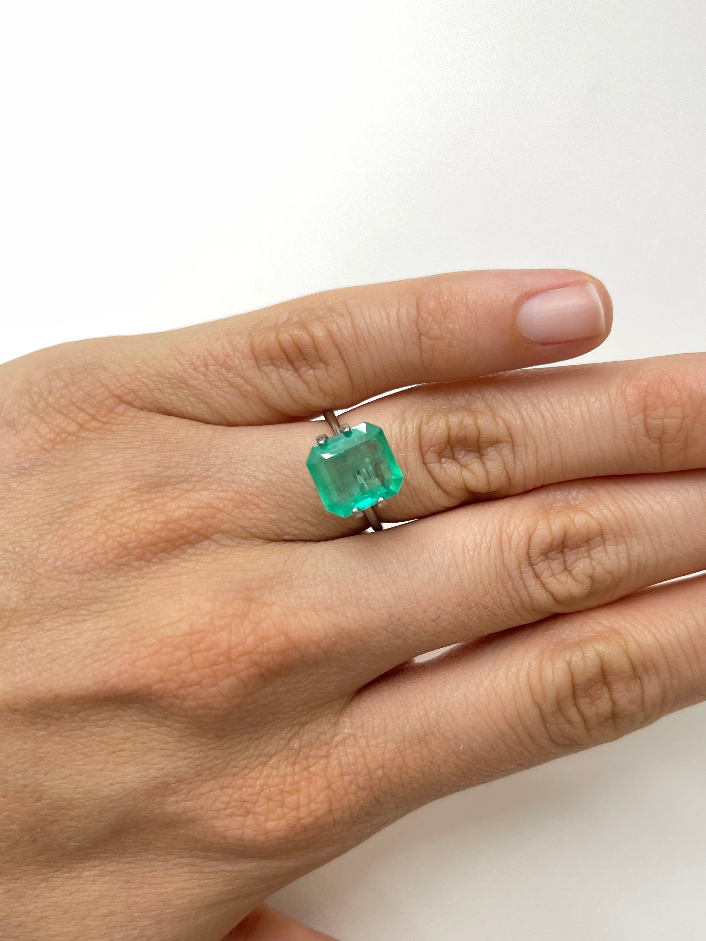 Spring green 3.59 carat Colombian emerald in Asscher cut, loose gemstone from JR Colombian Emeralds, showing its vibrant color and facets.
