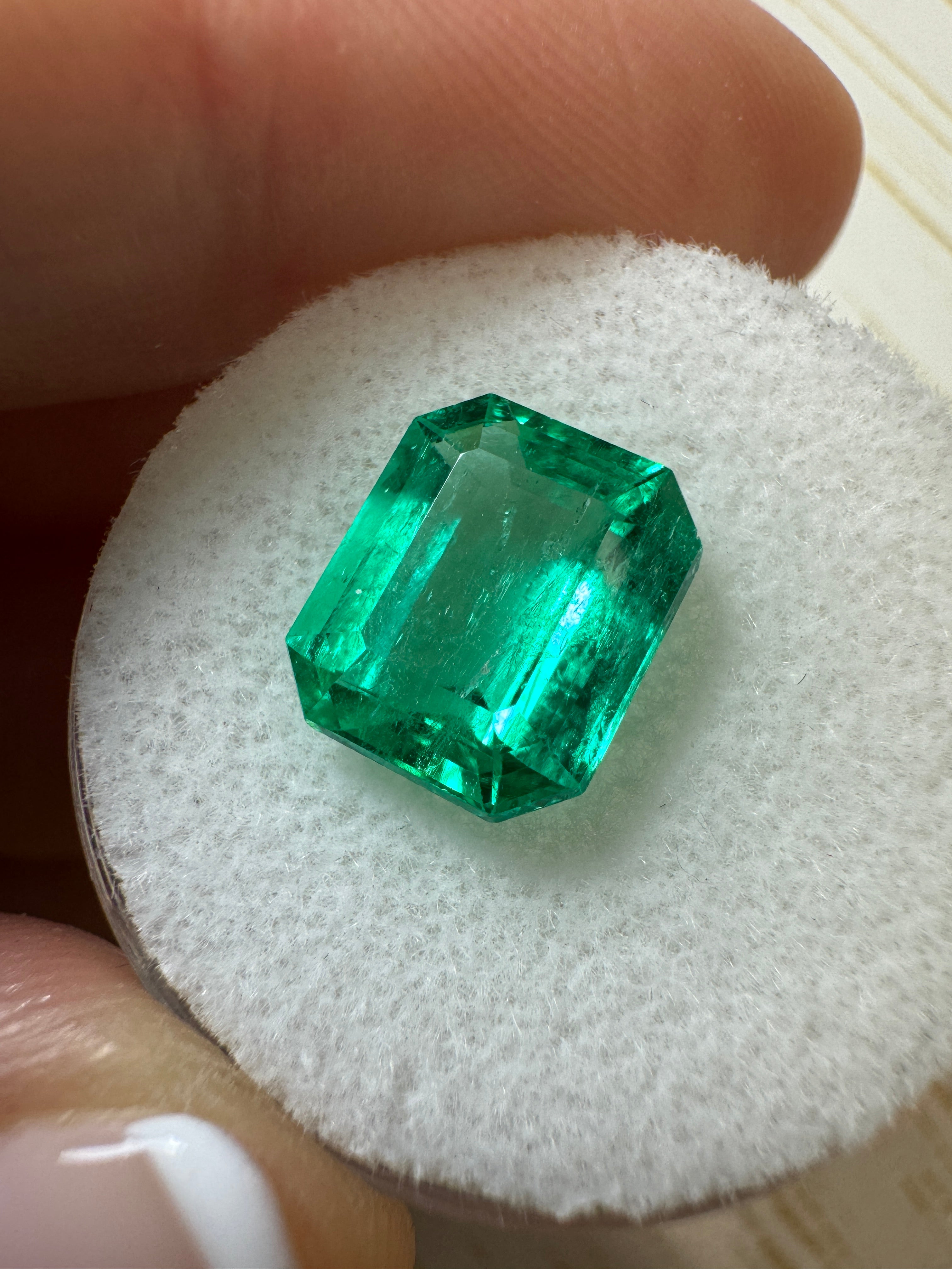 3.61 carat vivacious green natural Colombian emerald loose gemstone in an emerald cut, showcasing vibrant color and clarity.