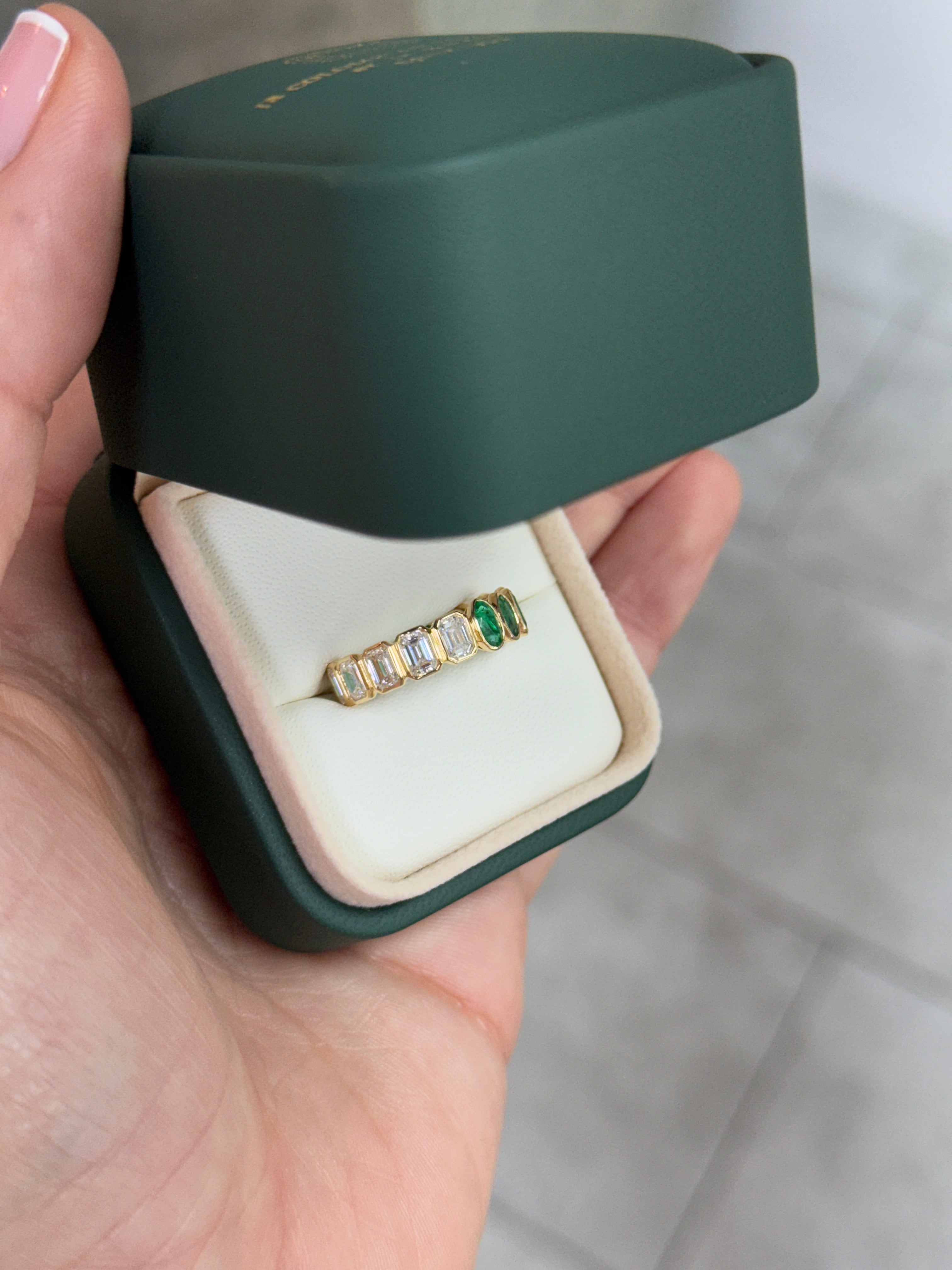 JR Colombian Emeralds 18K half oval and emerald cut diamond eternity band, 3.65 tcw, size 6.5, showcasing sparkling gemstones.