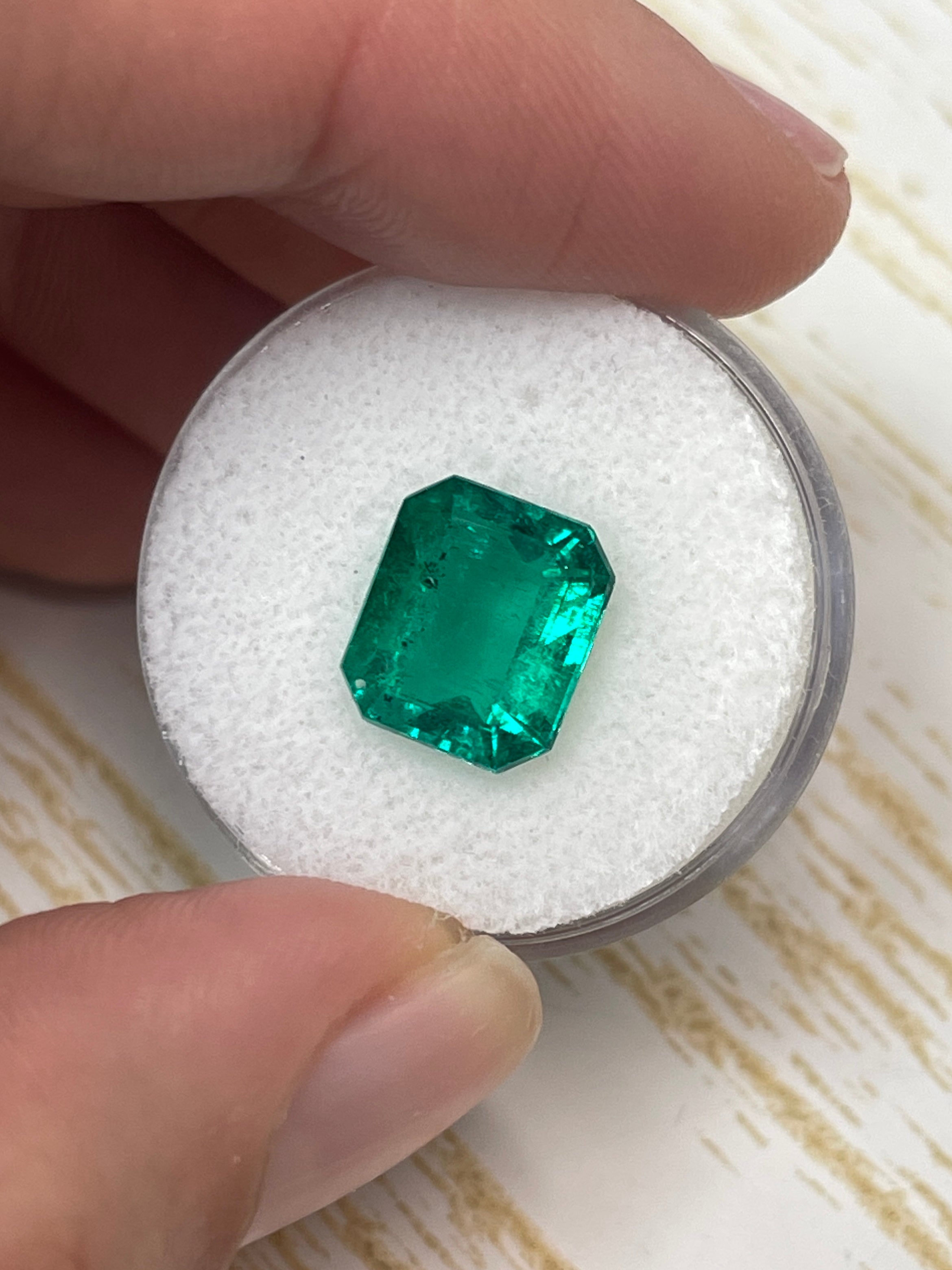 AAA+ 3.72 carat natural Colombian emerald loose gemstone in 11x9 emerald cut with green freckles, from JR Colombian Emeralds.