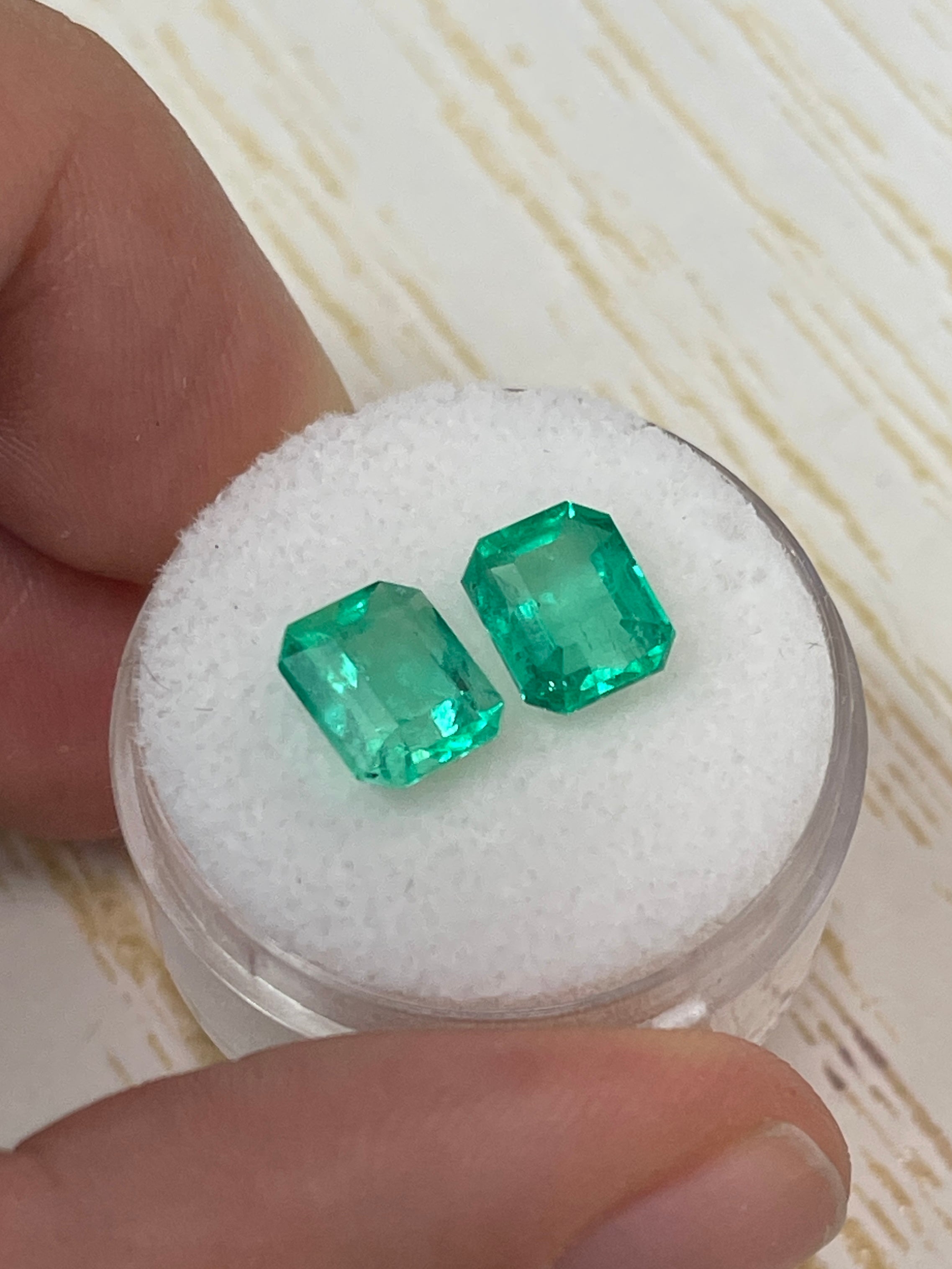 Matching 3.73 carat Colombian emeralds in 8x6.5mm emerald cut, loose green gemstones by JR Colombian Emeralds.