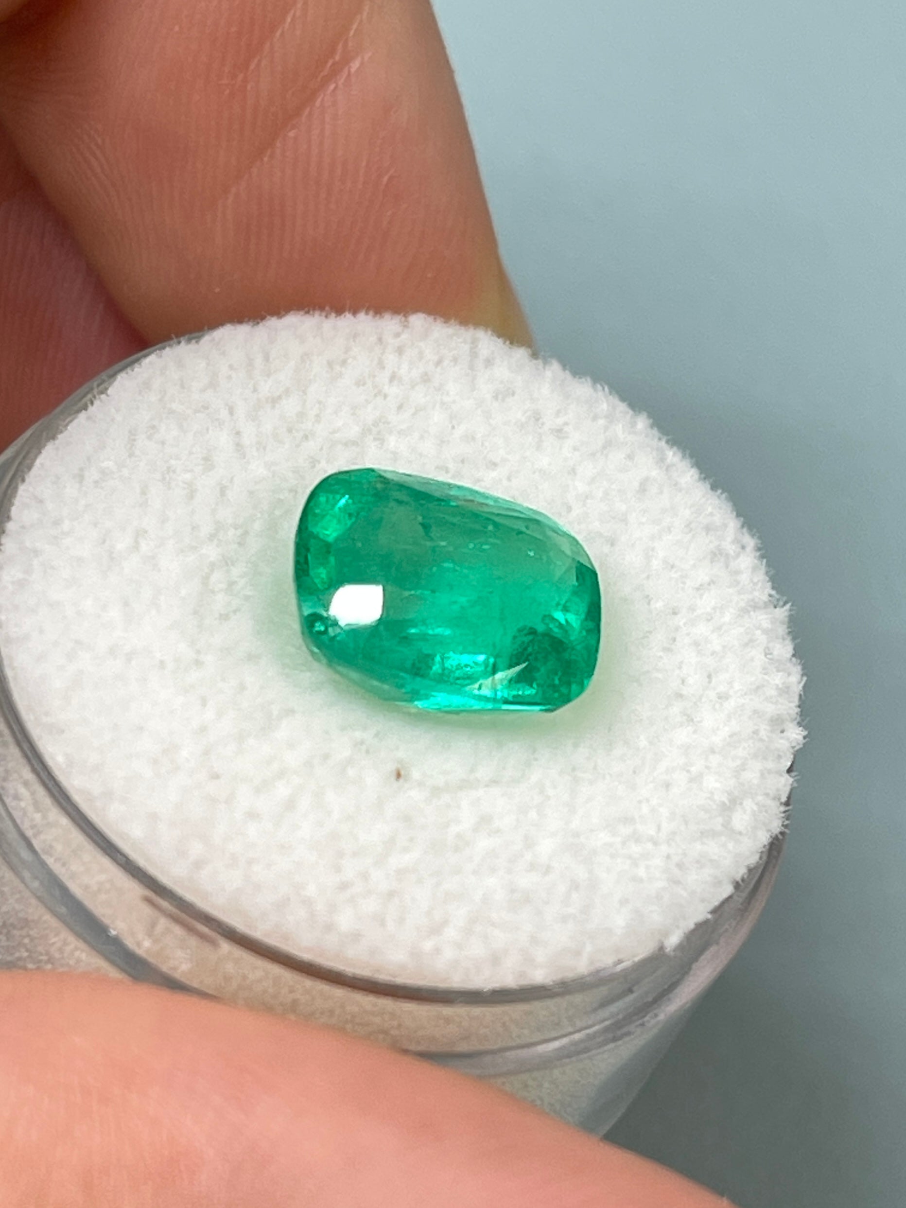 Loose 3.85 carat cushion cut Colombian emerald with medium green color, natural gemstone from JR Colombian Emeralds.