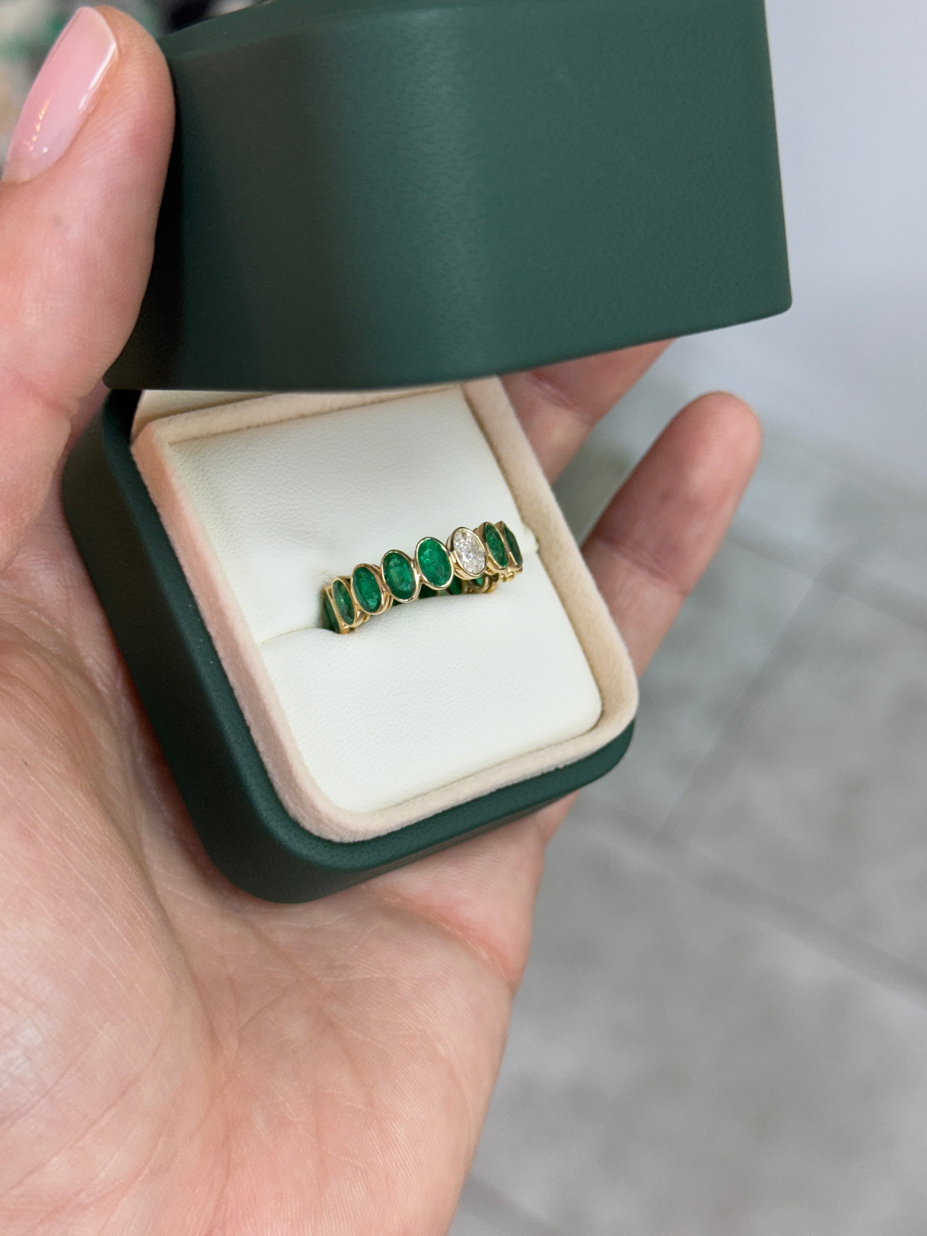JR Colombian Emeralds 3.86tcw bezel set oval emerald and diamond eternity band in size 6.5, showcasing vibrant gemstones and intricate design.