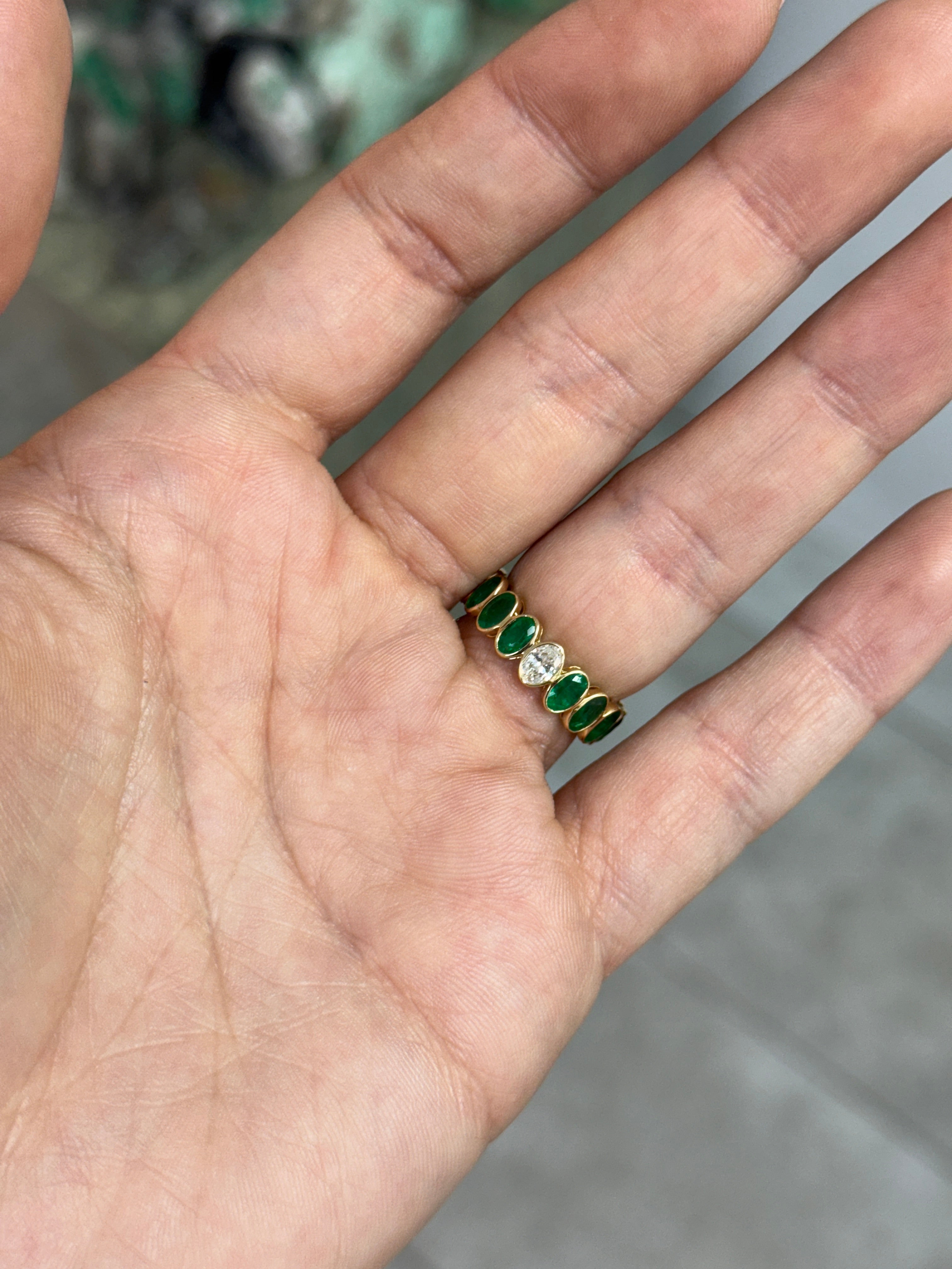 Bezel set oval emerald and diamond eternity band by JR Colombian Emeralds, 3.86tcw, size 6.5, featuring green emeralds and sparkling diamonds.