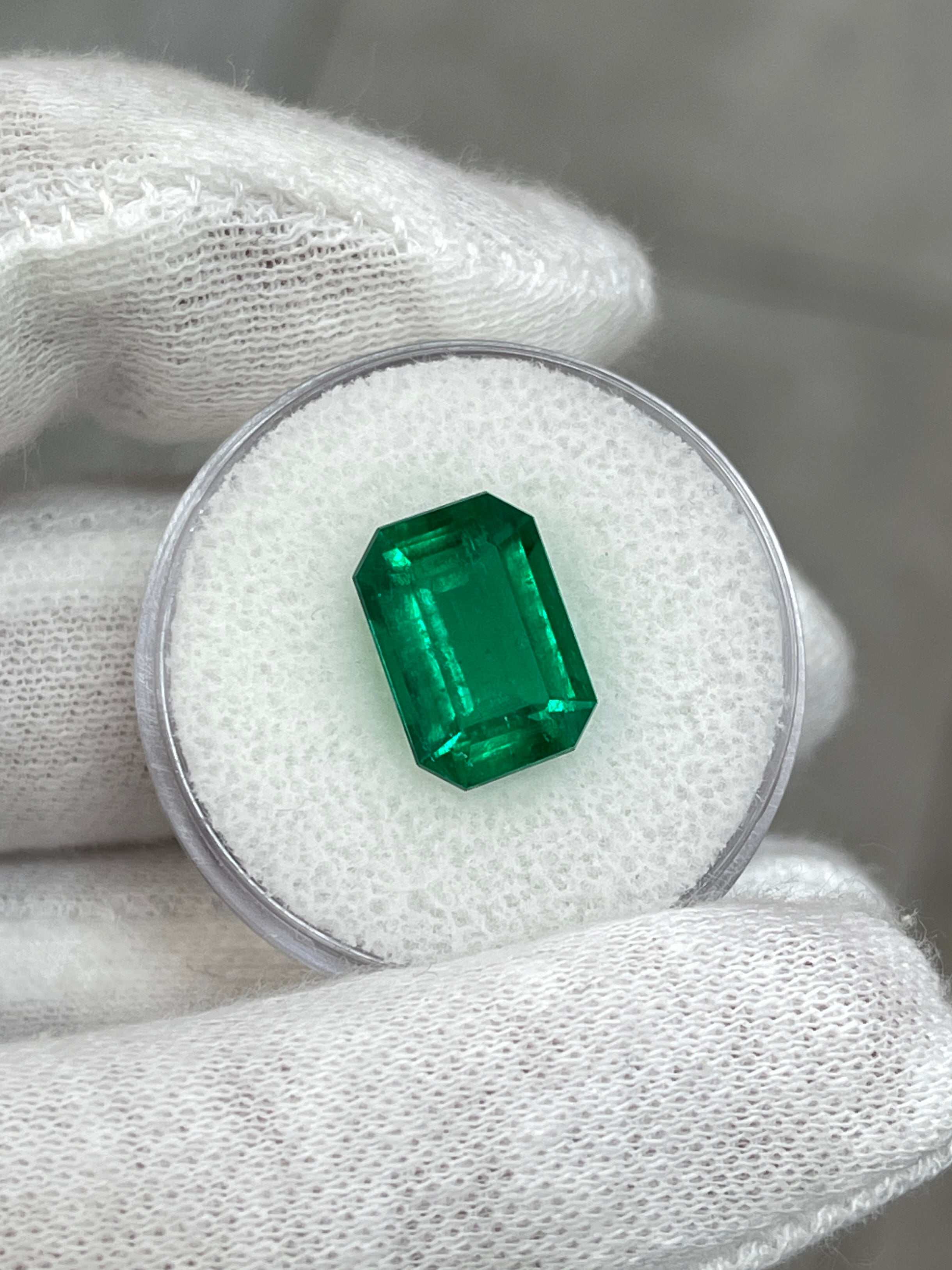 Vivid green 3.95 carat Colombian emerald cut loose emerald with GIA certification, showcasing vibrant color and clarity.