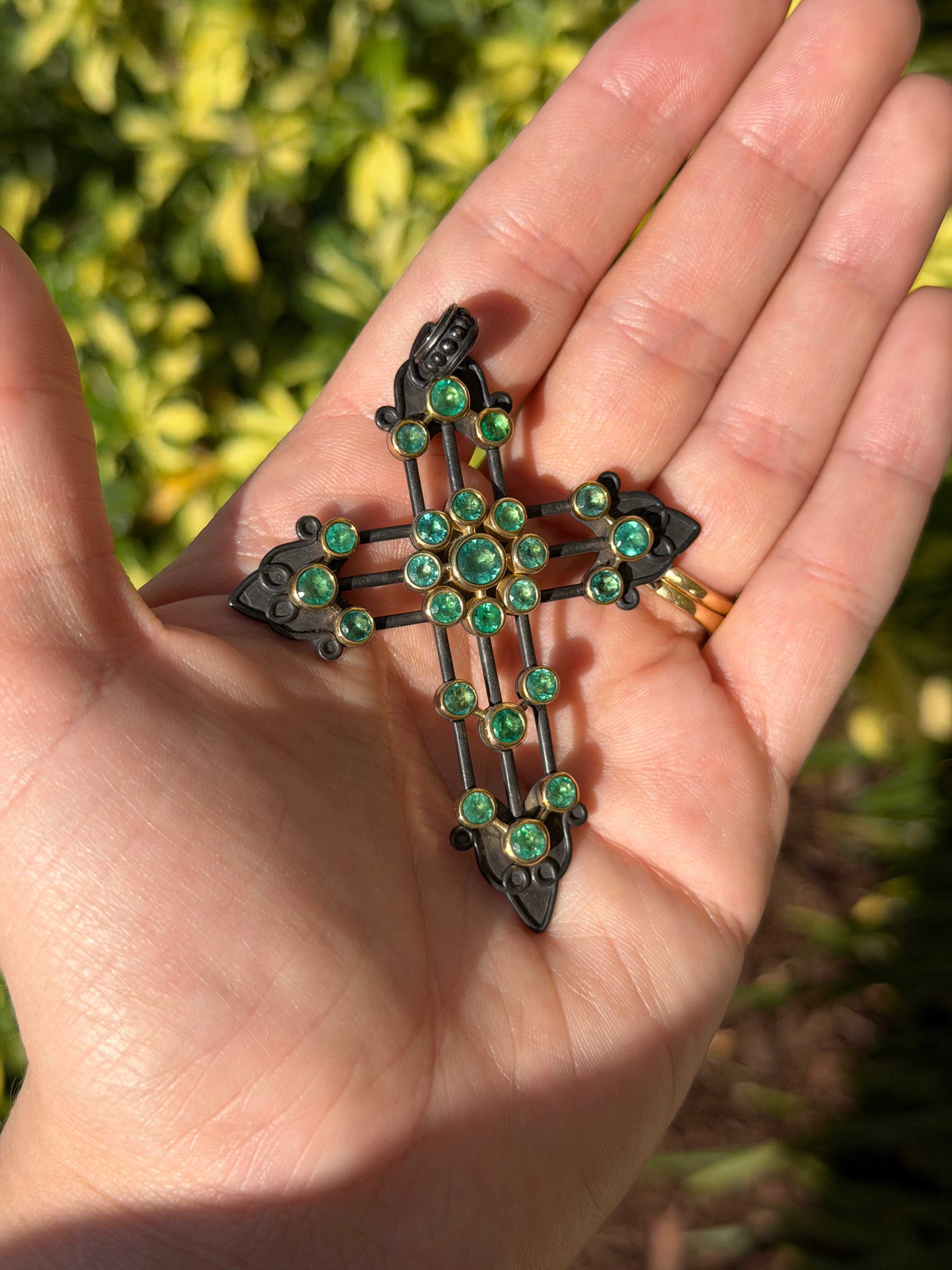 Gothic emerald crucifix pendant with 3.95 carats, 14K gold and blackened silver, featuring intricate design and emerald accents.