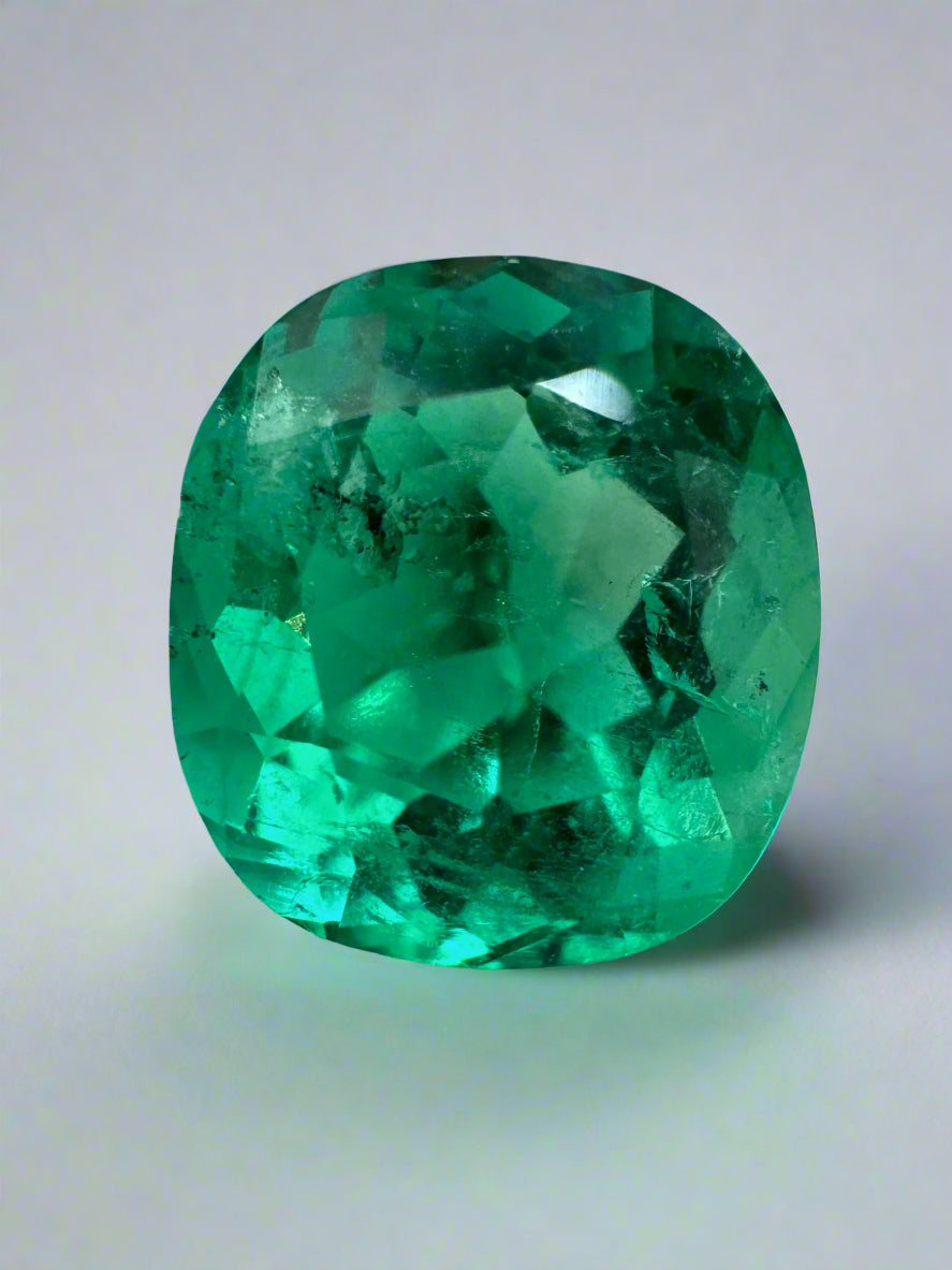 Vivid bluish green 4.96 Carat cushion cut loose emerald with natural freckles, from JR Colombian Emeralds.