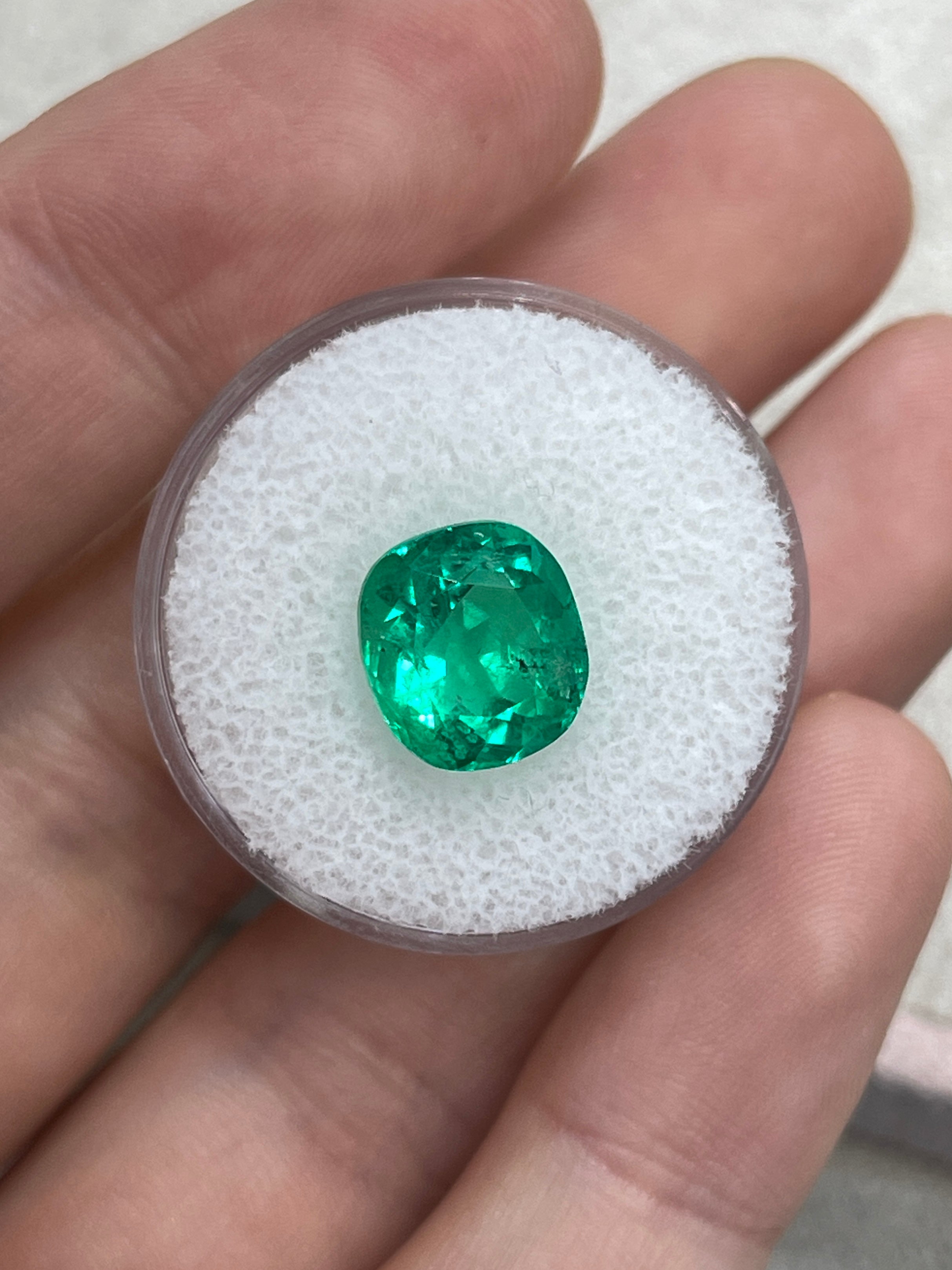 Freckled 4.96 Carat Vivid Bluish Green Cushion Cut Loose Emerald by JR Colombian Emeralds, showcasing its vibrant color and unique inclusions.