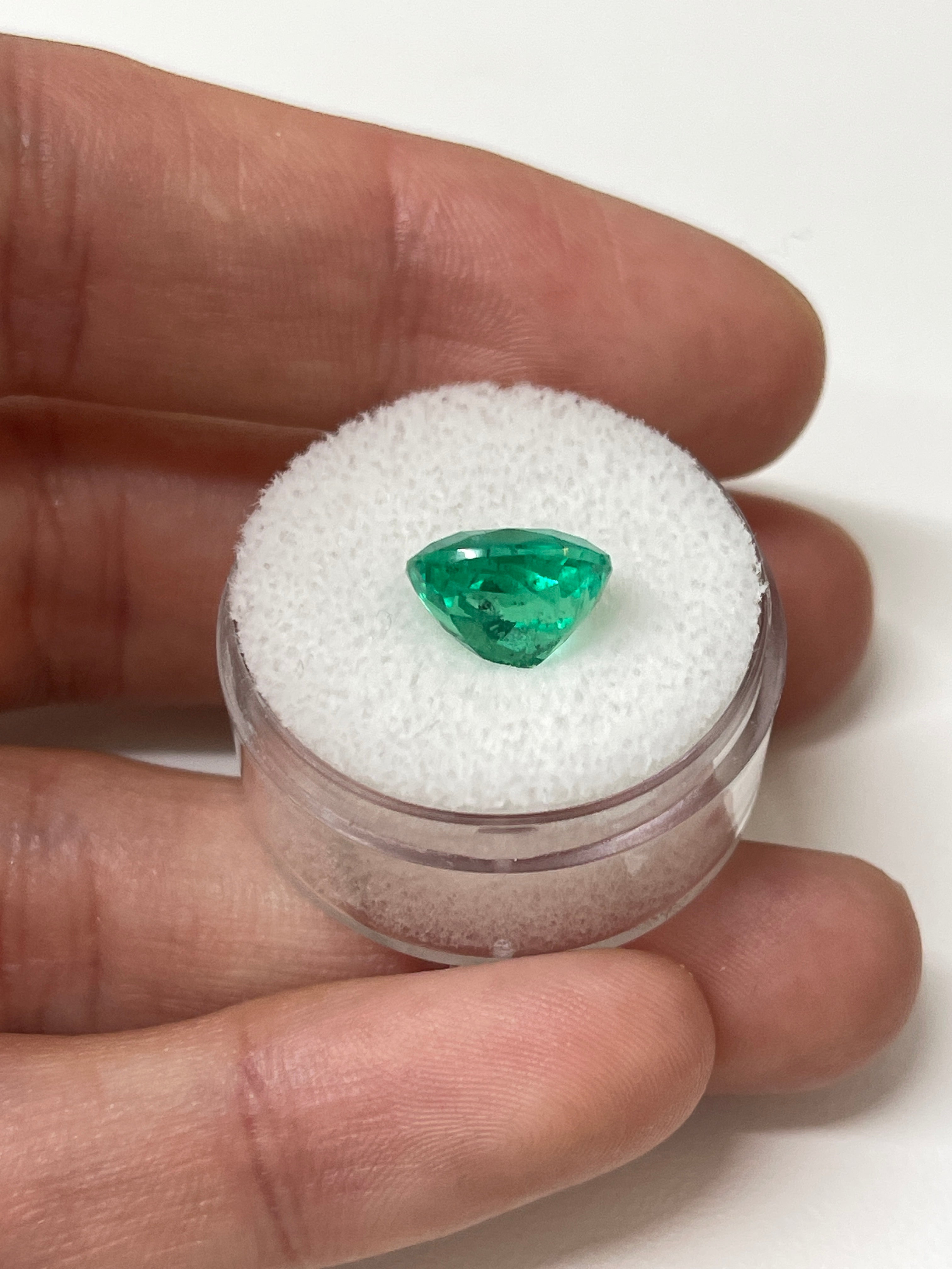 Vivid bluish green 4.96 carat cushion cut loose emerald with natural freckles from JR Colombian Emeralds.