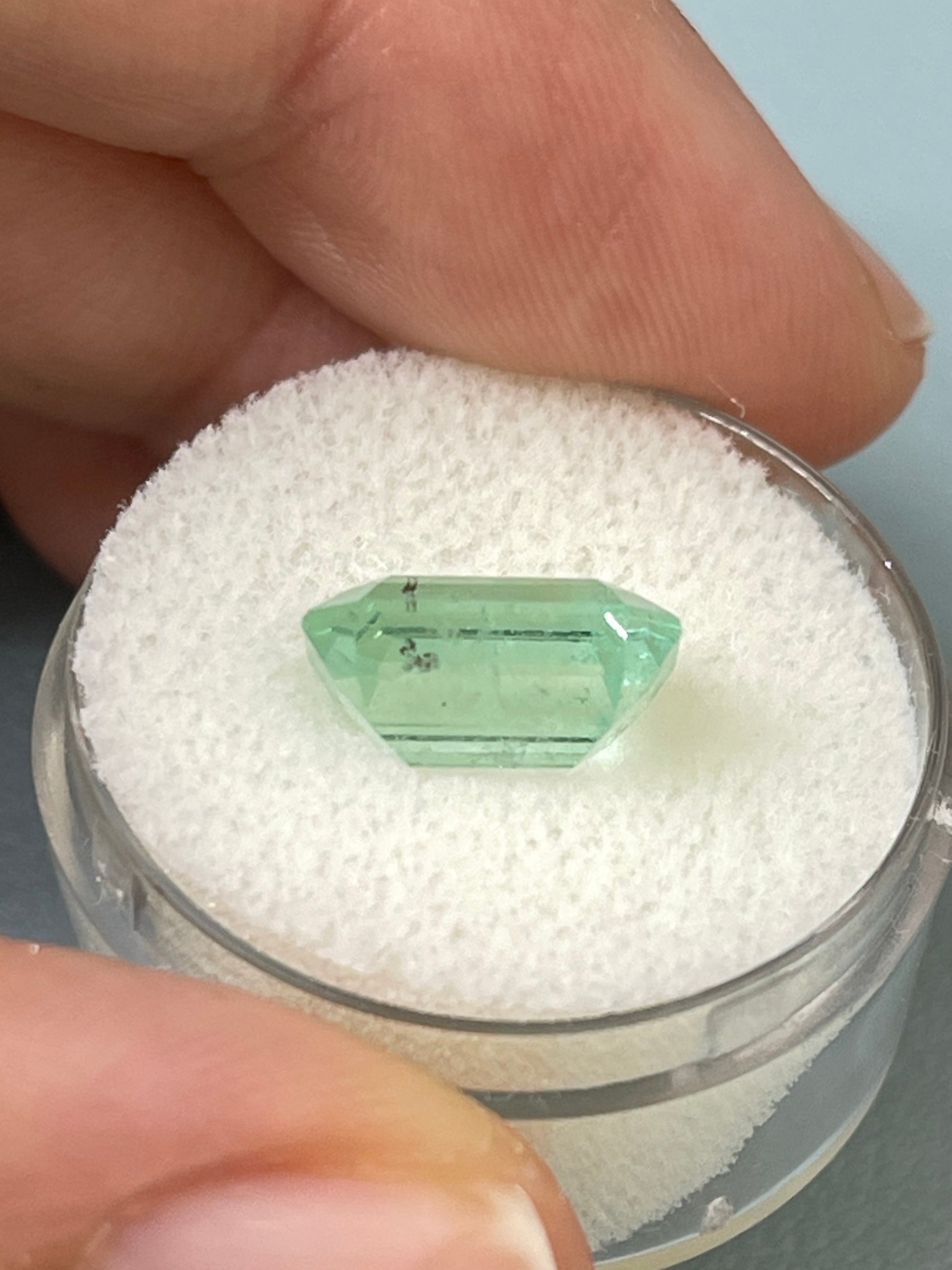 Light green 4.06 carat Colombian emerald loose gemstone with natural freckles, classic emerald cut, from JR Colombian Emeralds.