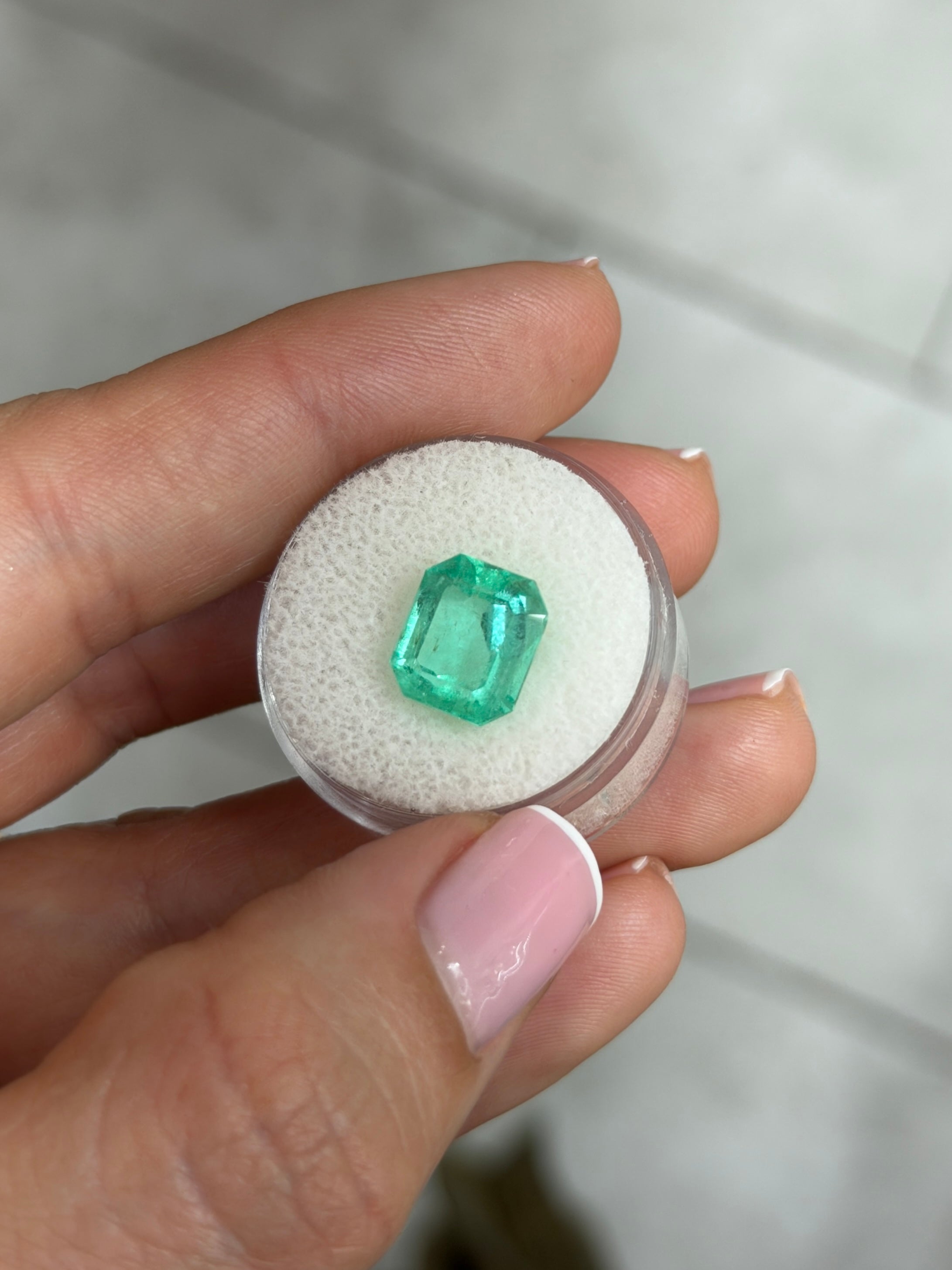 Medium light bluish green 4.12 carat Colombian emerald in chunky emerald cut, natural loose gemstone from JR Colombian Emeralds.