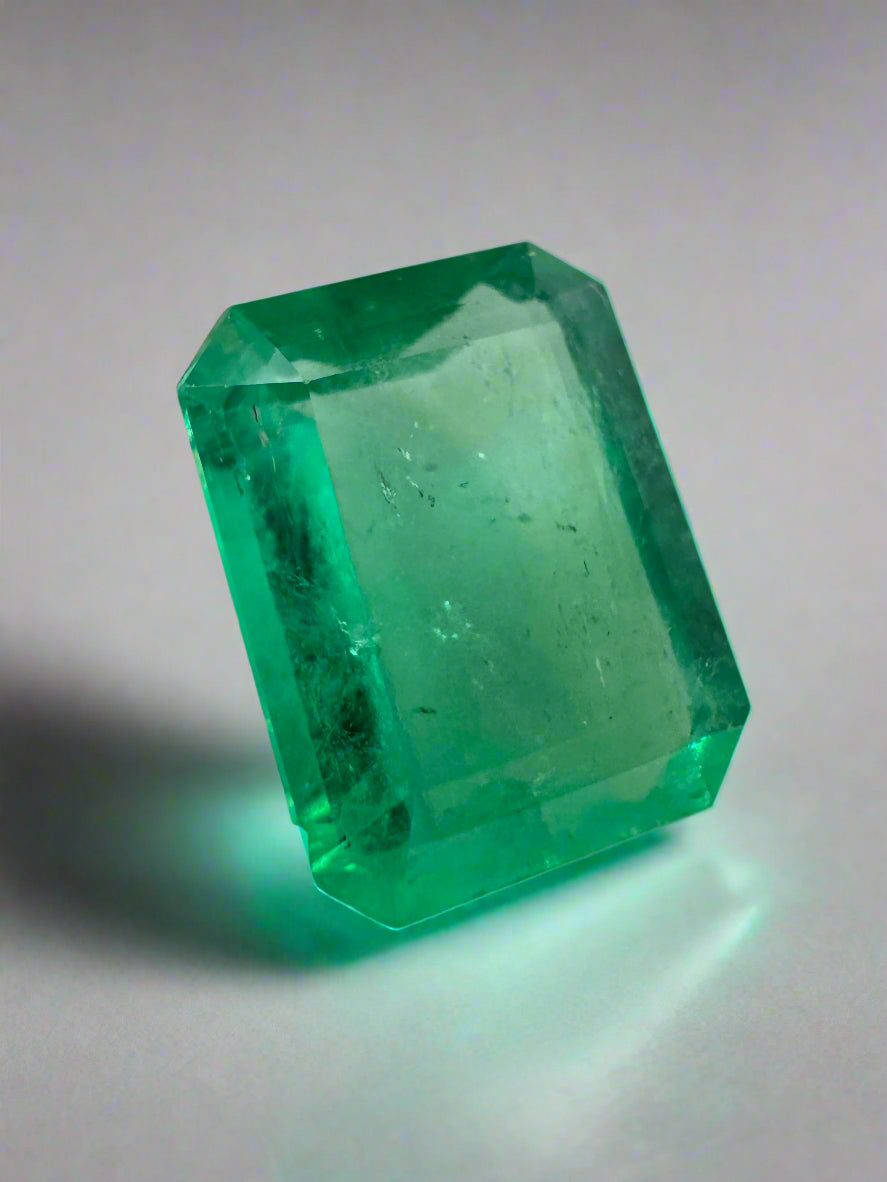 4.12 carat natural Colombian emerald loose gemstone in 12x9mm portrait cut, showcasing rich green color and clarity.