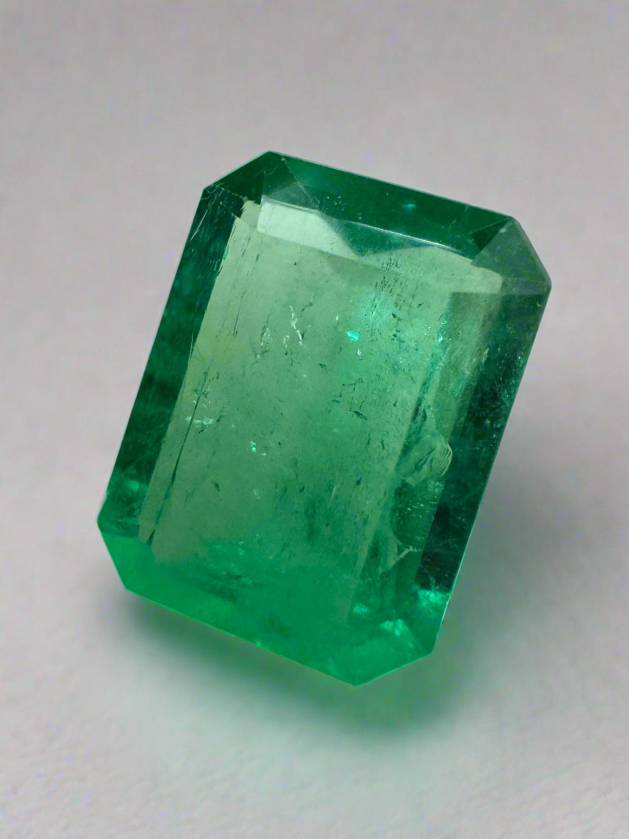 Natural 4.12 carat Colombian emerald loose gemstone with 12x9mm portrait cut, showcasing rich green color and clarity.