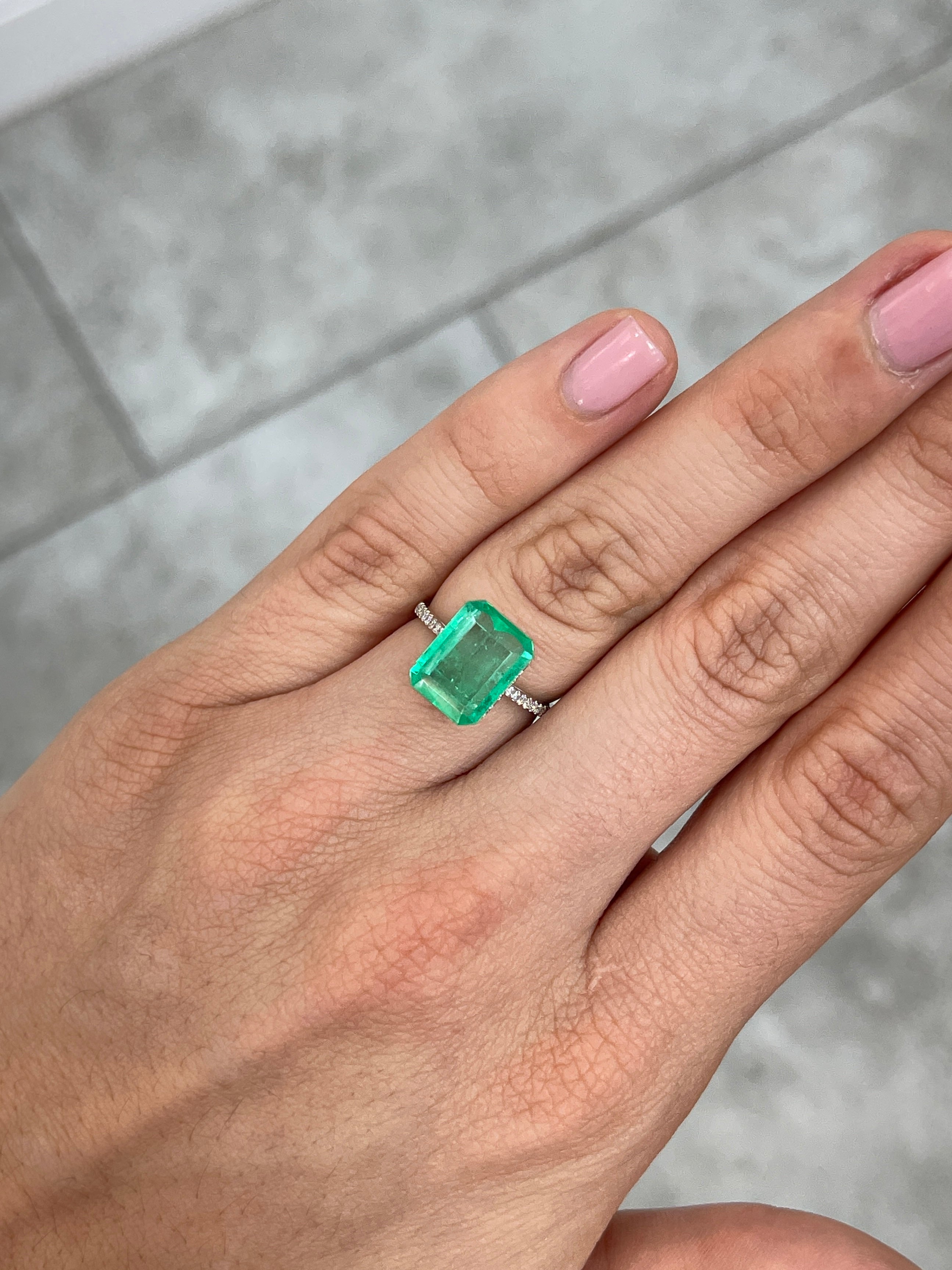 4.12 carat natural Colombian emerald loose gemstone in 12x9 mm portrait cut showing vibrant green color and clarity.