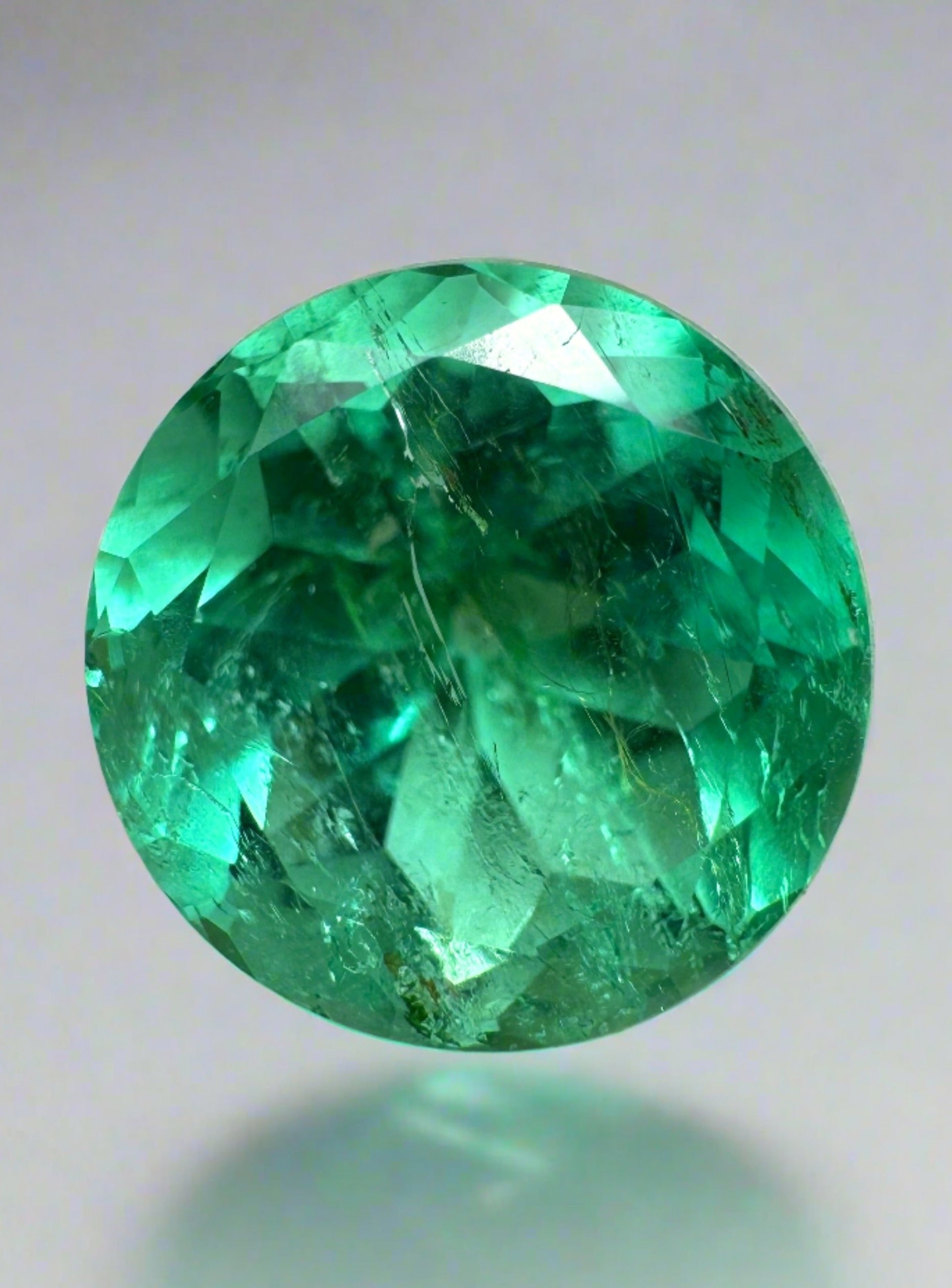 4.14 carat natural round Colombian emerald loose gemstone with vibrant green color, certified by JR Colombian Emeralds.