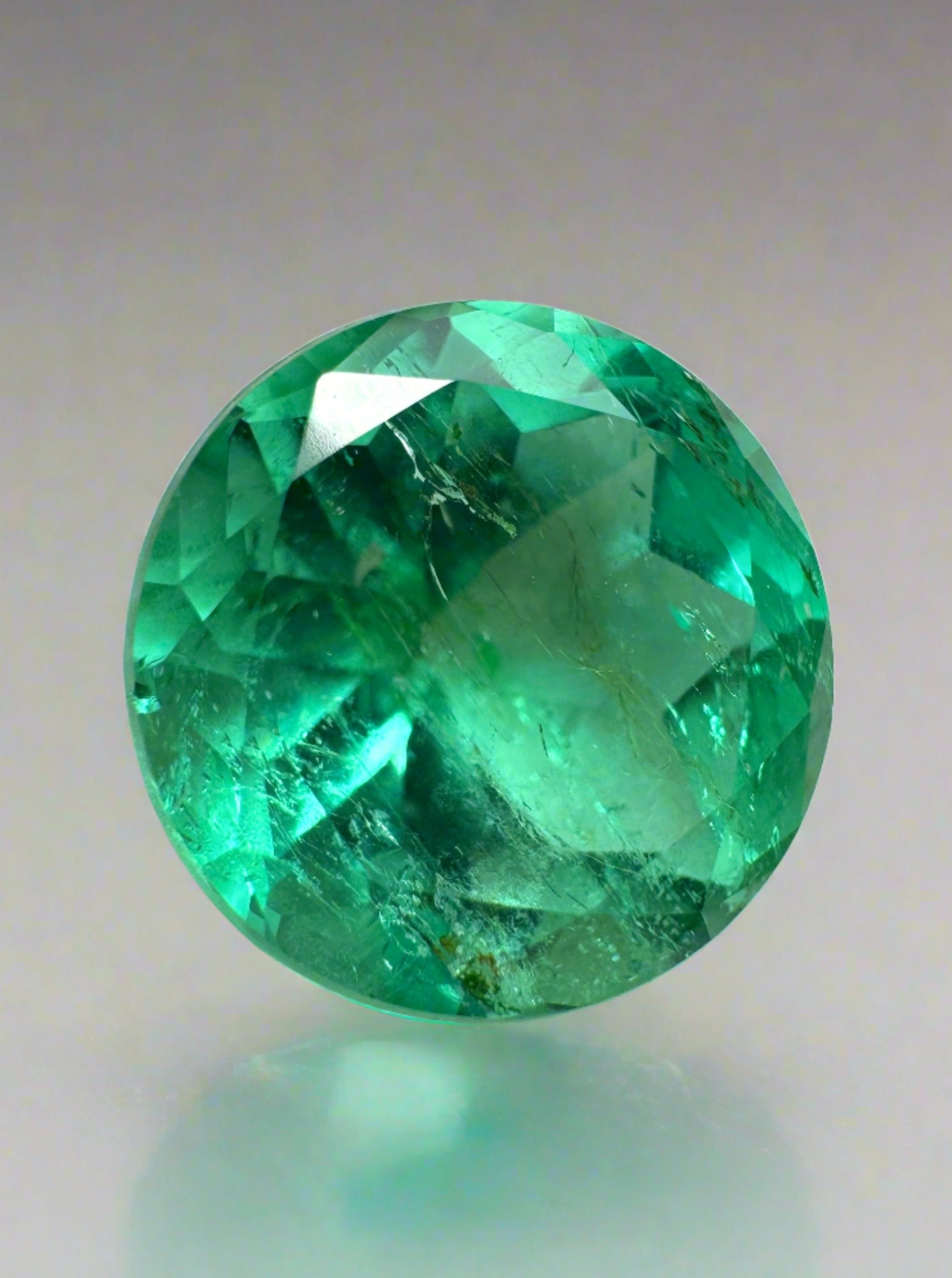 4.14 carat natural round Colombian emerald gemstone, vibrant green, loose and certified by JR Colombian Emeralds.