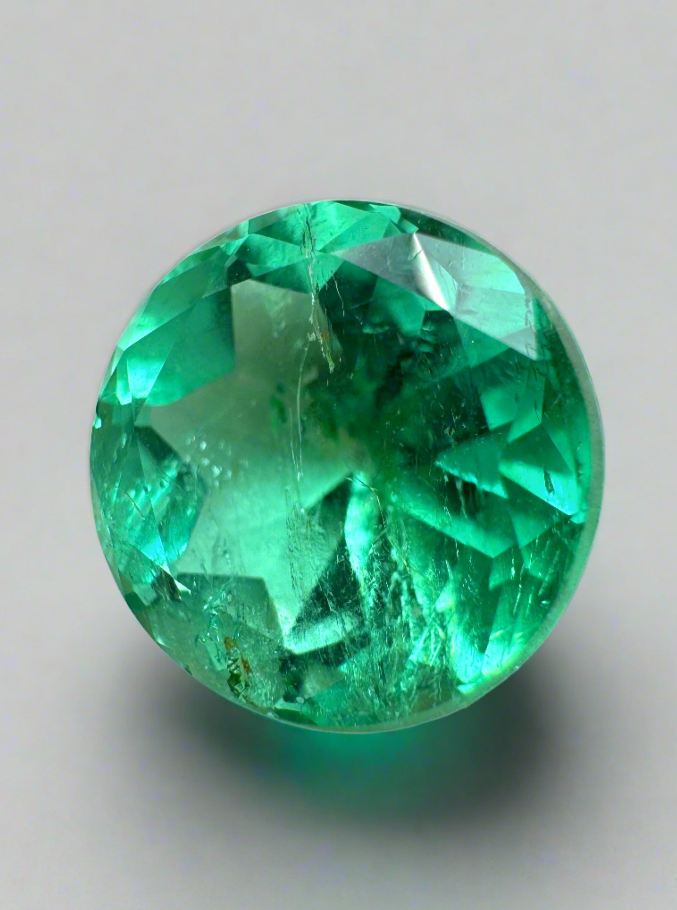 4.14 carat certified green Colombian emerald, natural round loose gemstone with a vibrant, rich green color.