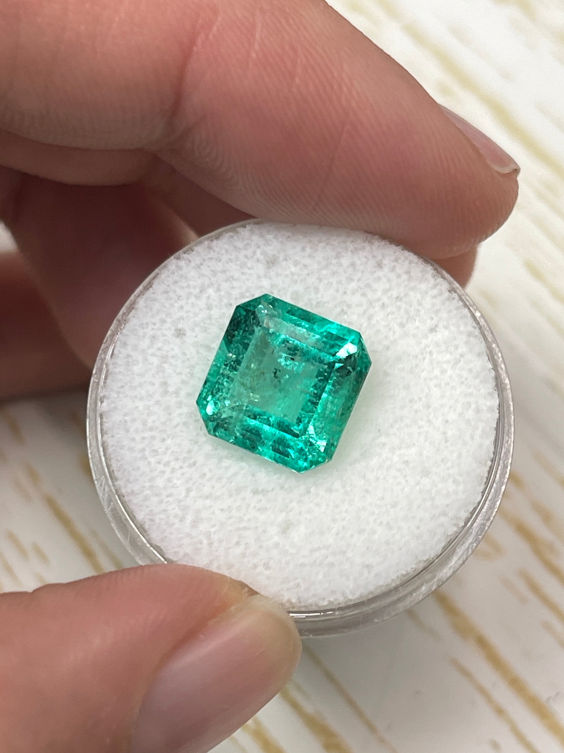 Vibrant 4.33 carat 10x10mm loose Colombian emerald in Asscher cut, from JR Colombian Emeralds. Bright green gemstone.